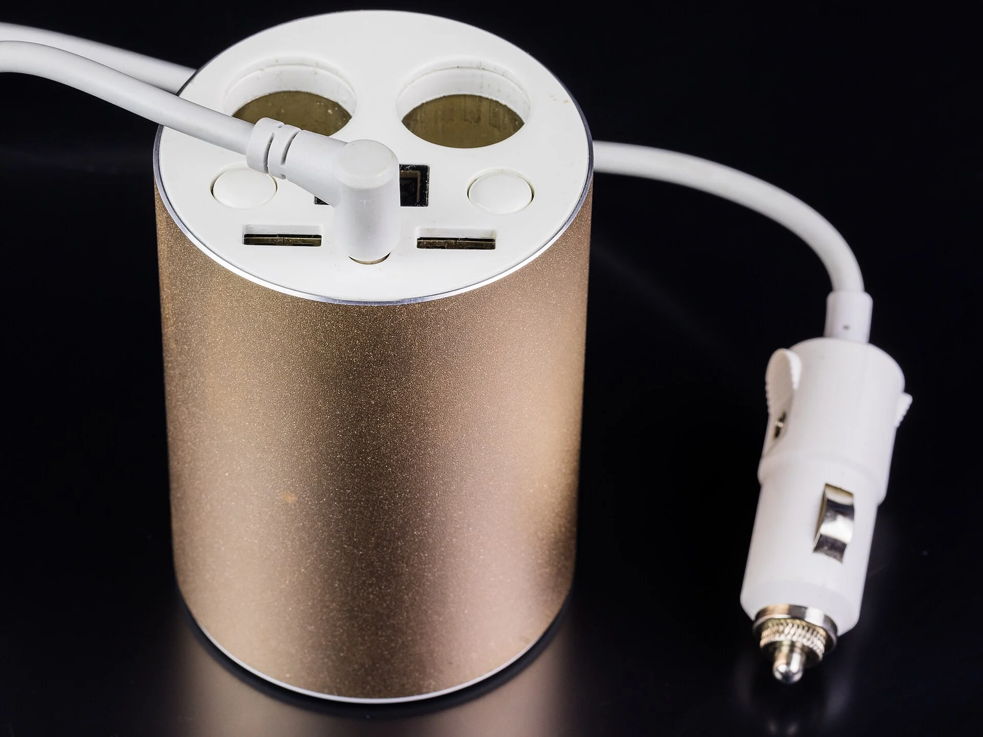 A cup-holder car charger with twin 12-volt sockets and USB ports, one of the multi-device options compared