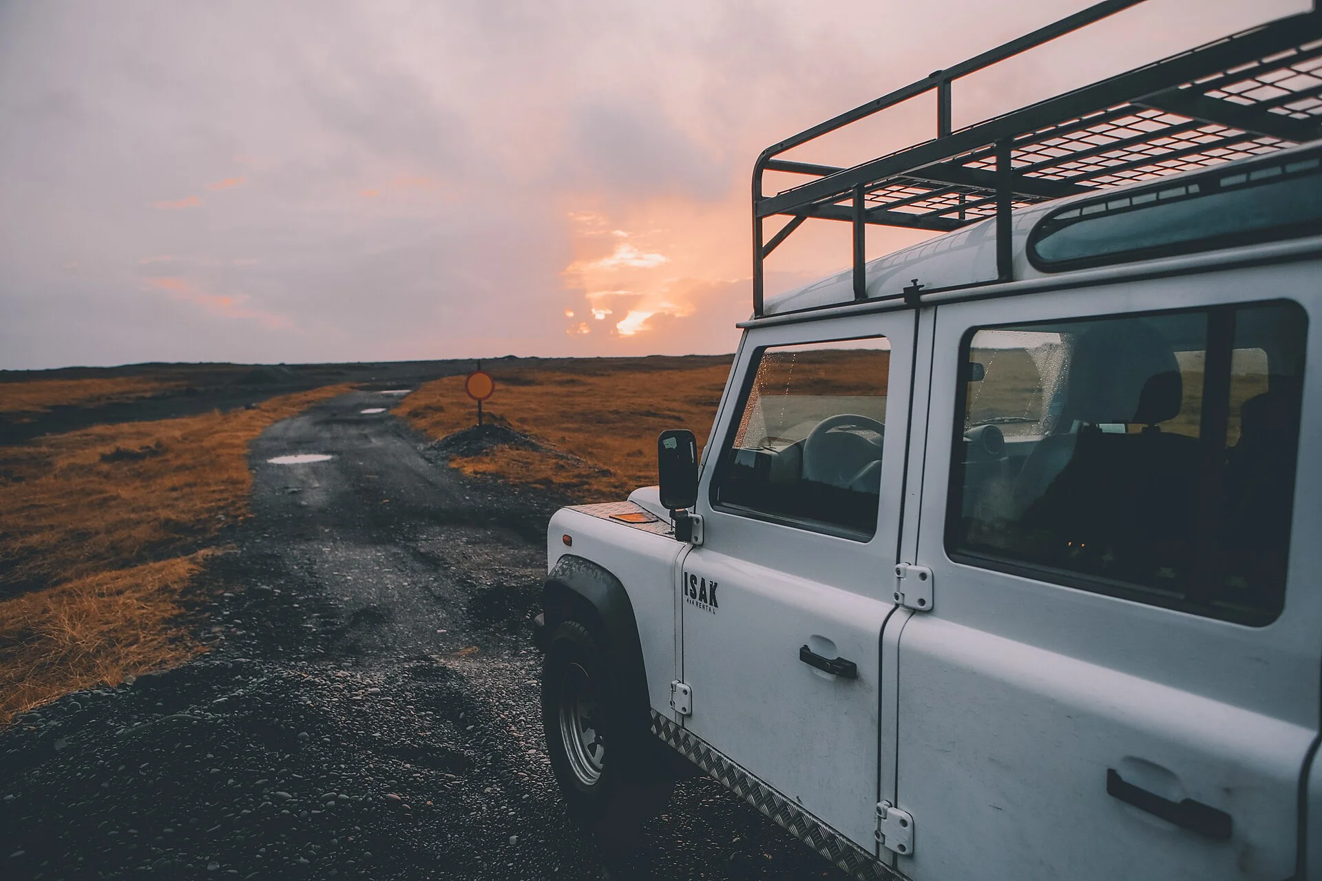 A white SUV on a remote dirt road, ready for off-road camping trips.