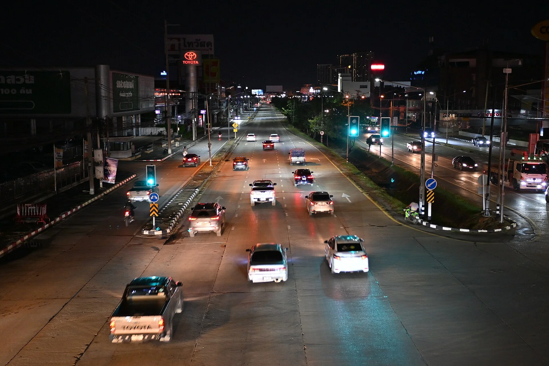 Cars driving down a city street at night, where low-light dash cam performance matters most.