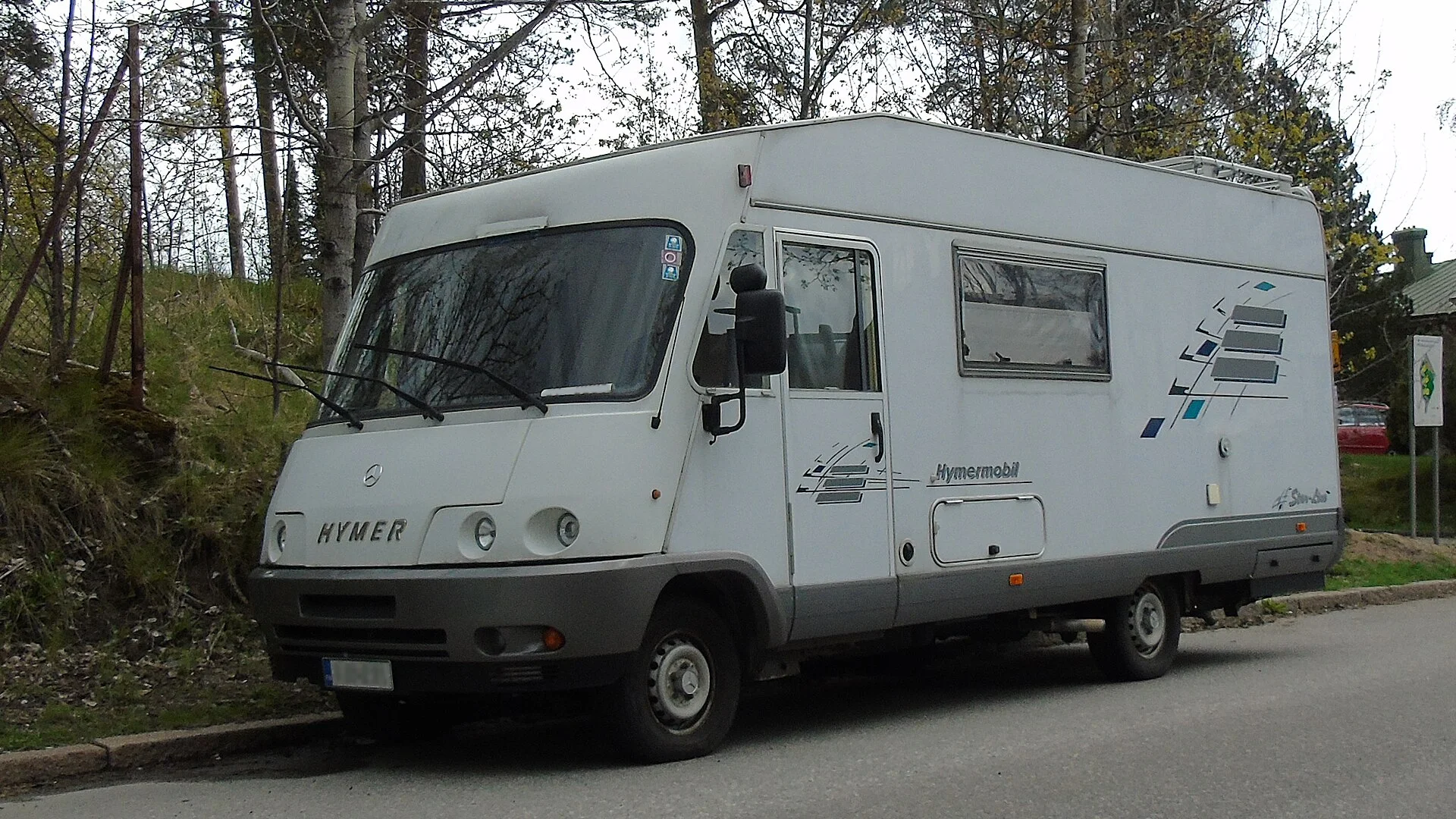 A motorhome on the road, where a rear-view dash cam aids reversing and towing.