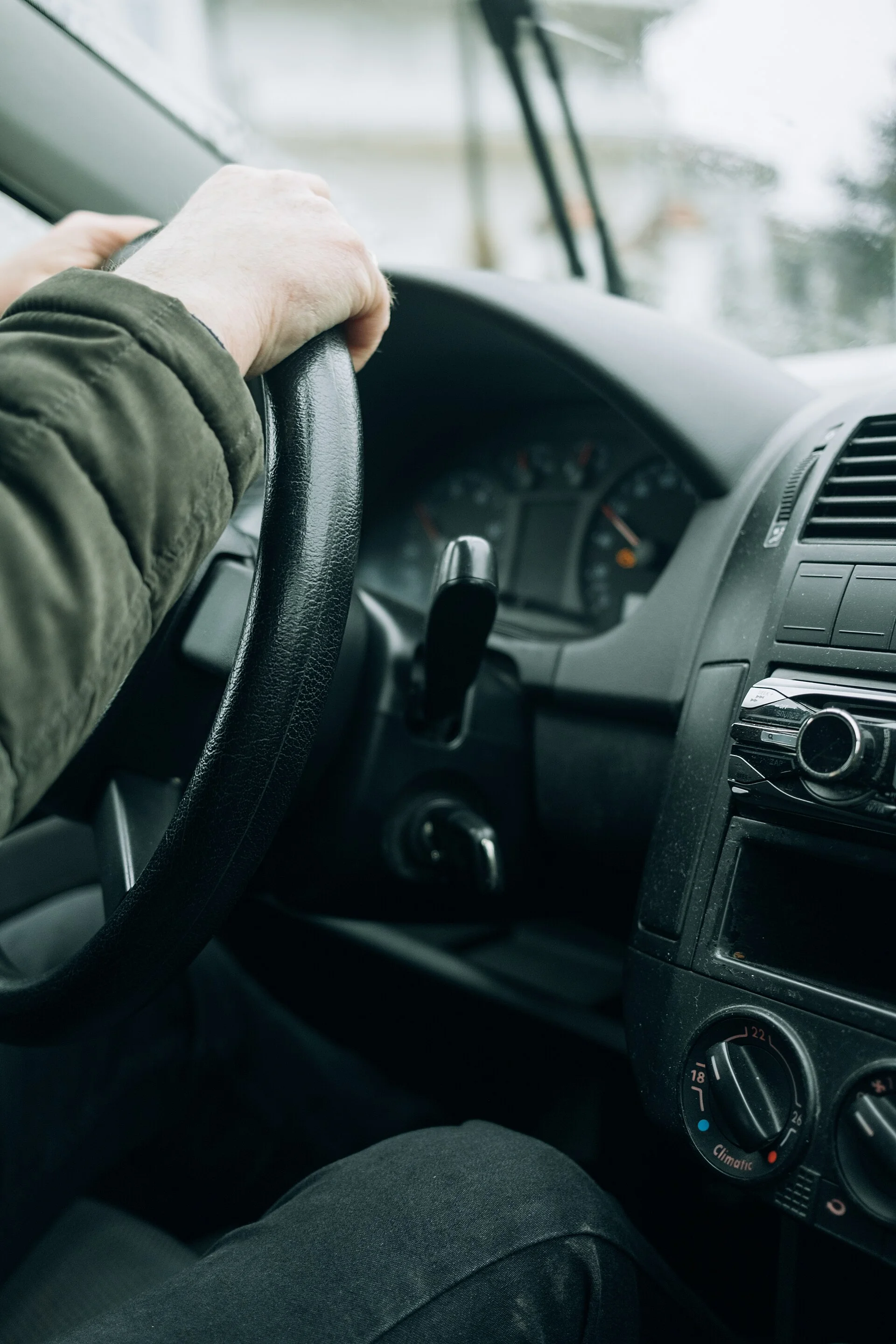 A driver focused on the road behind the wheel, the daily reality for rideshare drivers.