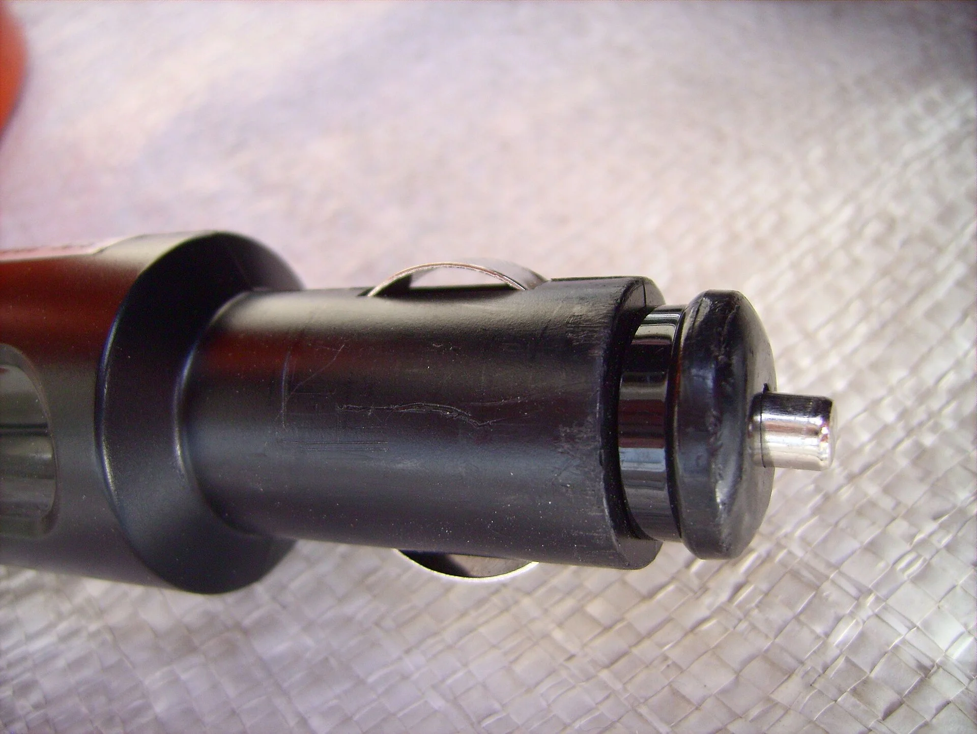 A black 12-volt car accessory plug of the type that fits a cigarette-lighter socket.