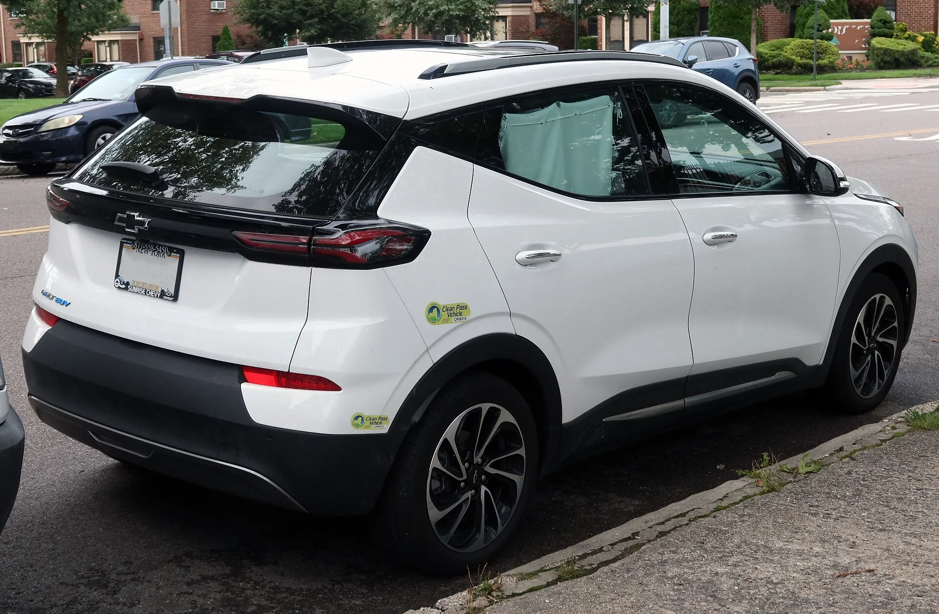 A Chevy Bolt EUV (rear view), the larger Bolt variant, showing the hatch and cargo opening used for a camping setup.