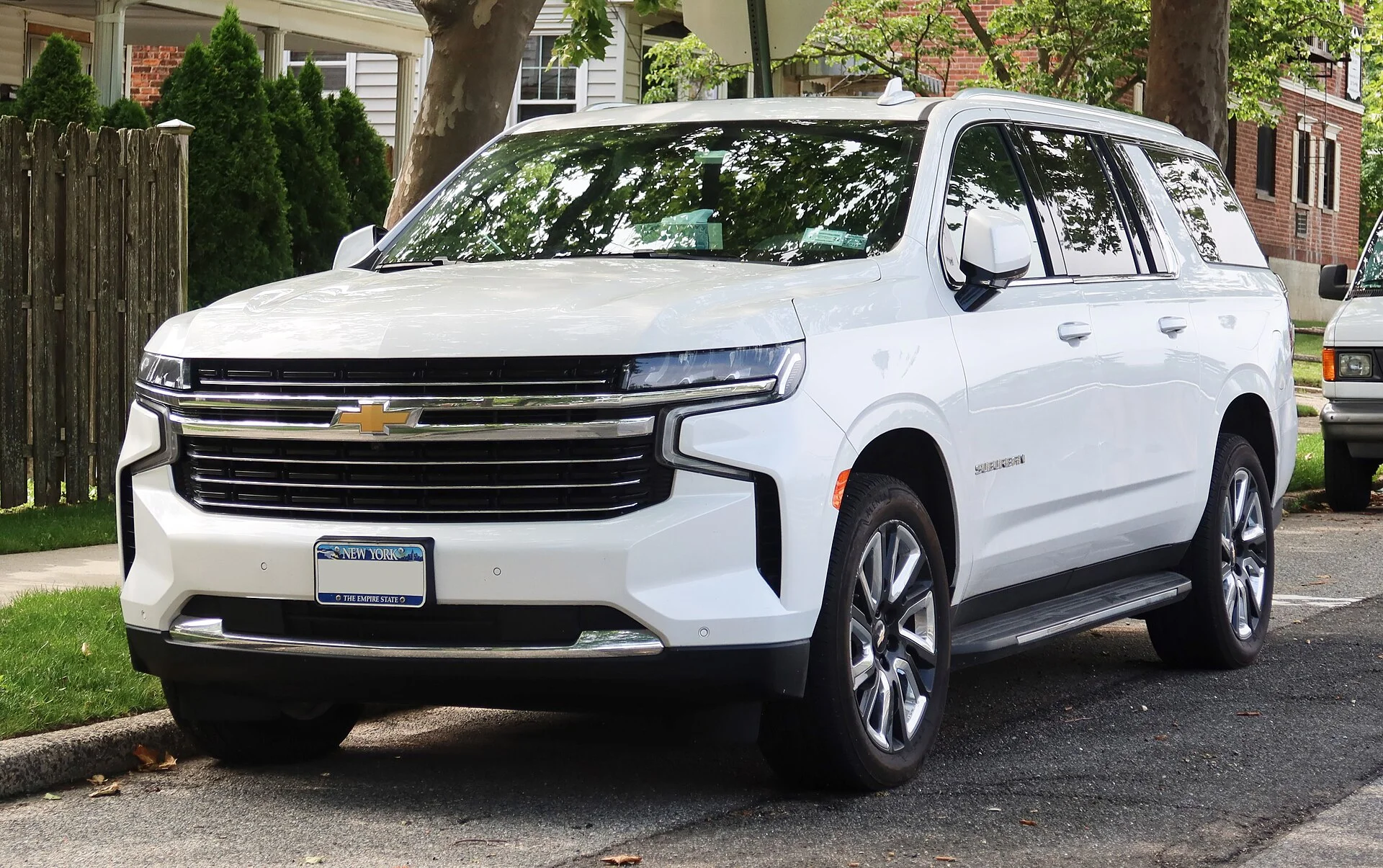 Chevy Suburban — a white 2021 Suburban LT, front three-quarter view