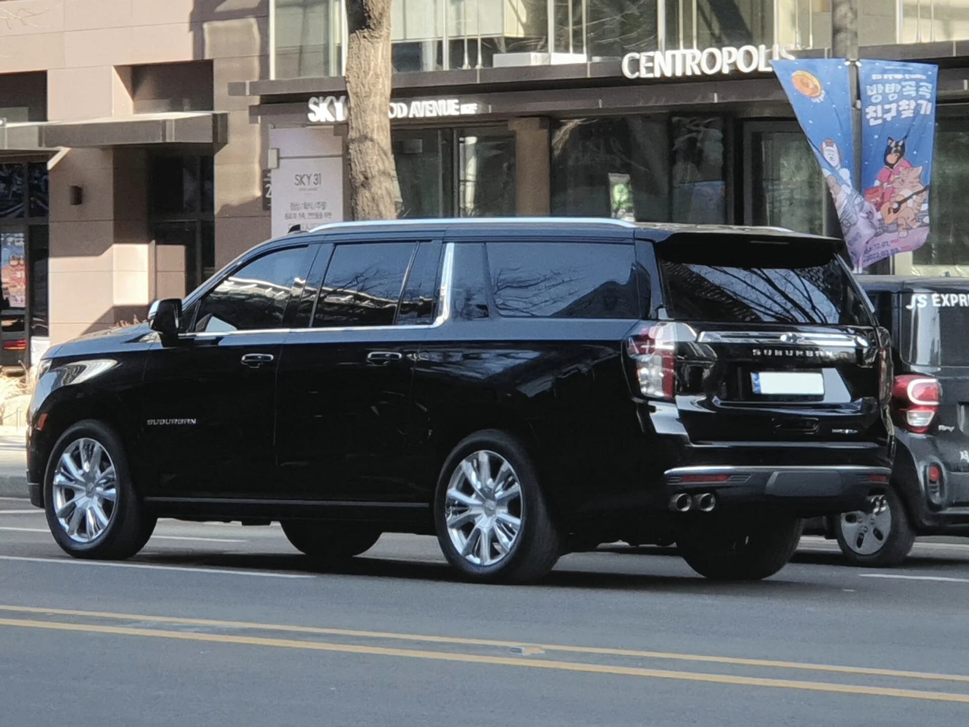 Chevy Suburban High Country — a black 2021 Suburban, side profile