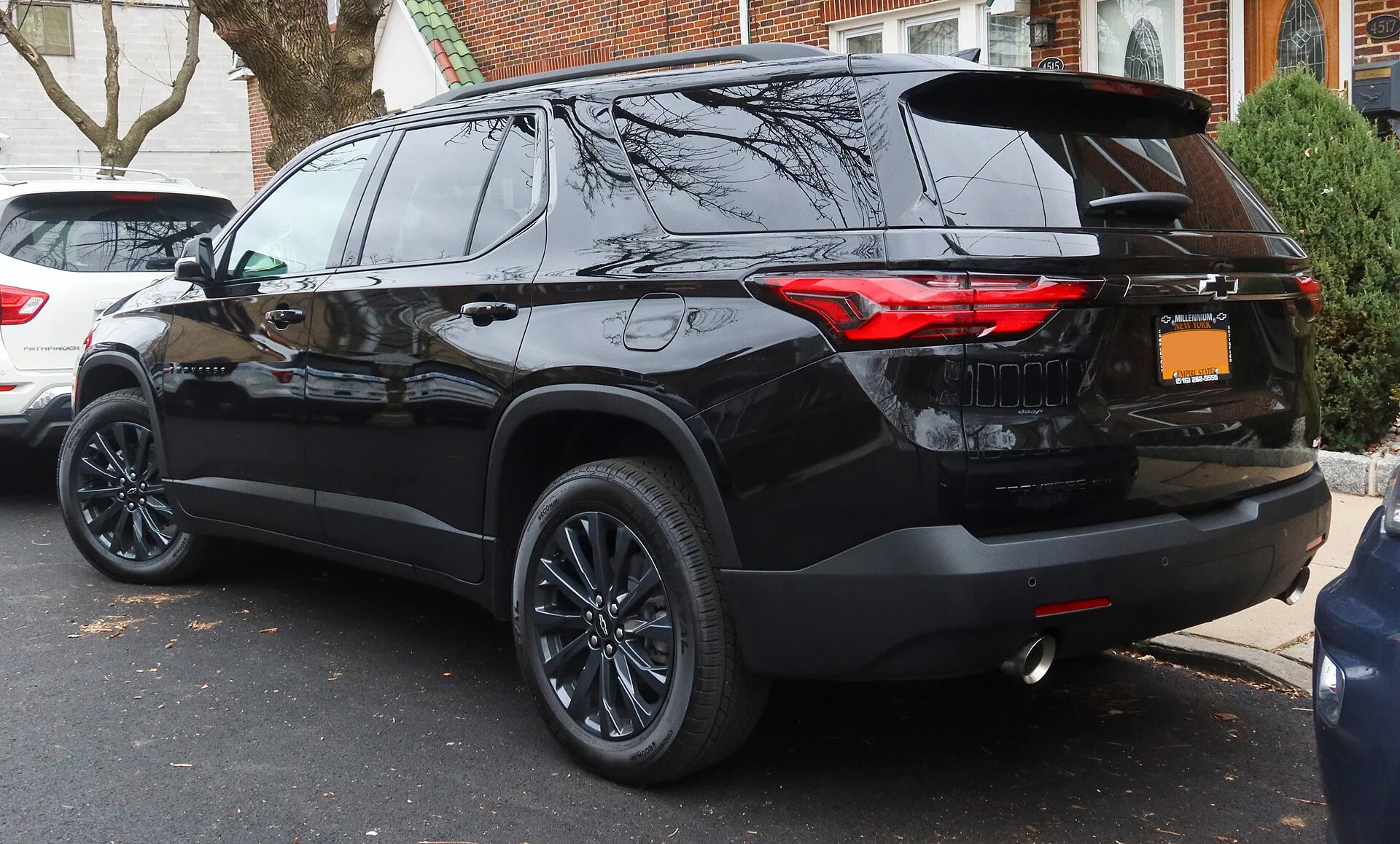 Black 2022 Chevy Traverse RS SUV, rear three-quarter view on a street