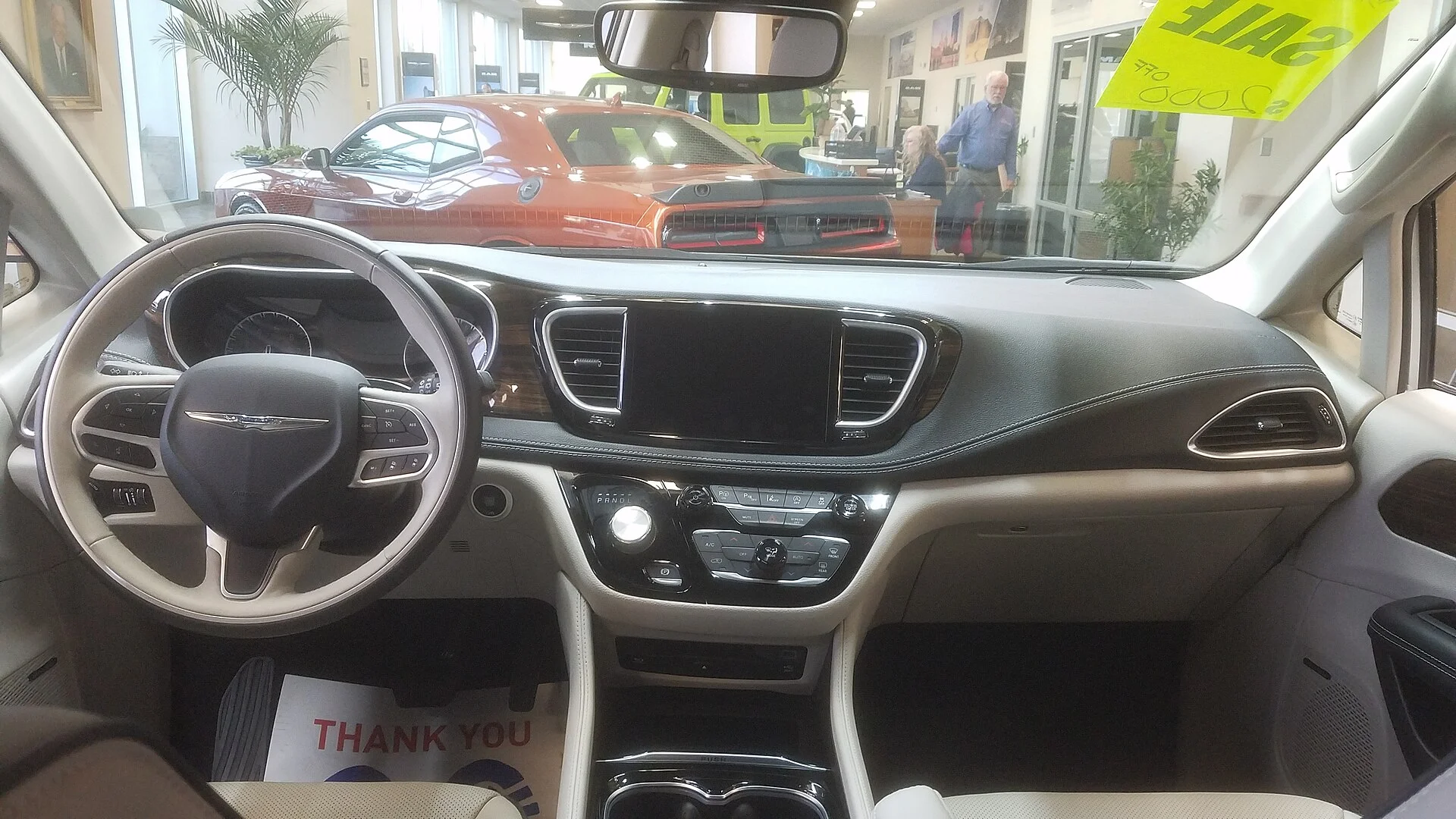 A Chrysler Pacifica dashboard and front cabin, the minivan interior this Stow 'n Go camper build works within