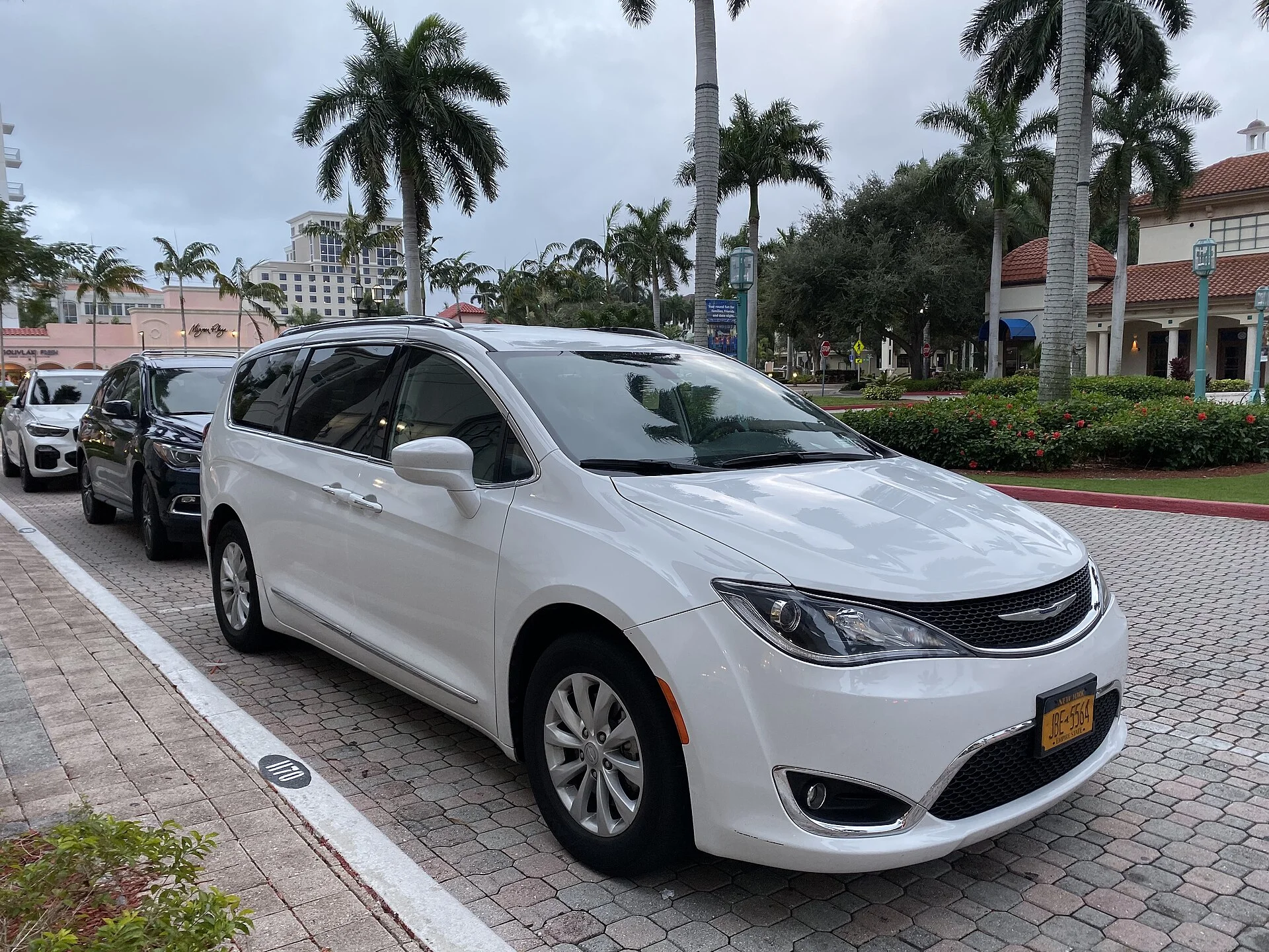 A Chrysler Pacifica in white, the current-generation minivan whose fold-flat seats sleep four