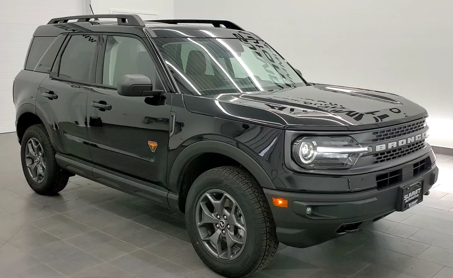A Ford Bronco Sport Badlands (front view) in green, the off-road trim this Bronco Sport camping guide highlights.