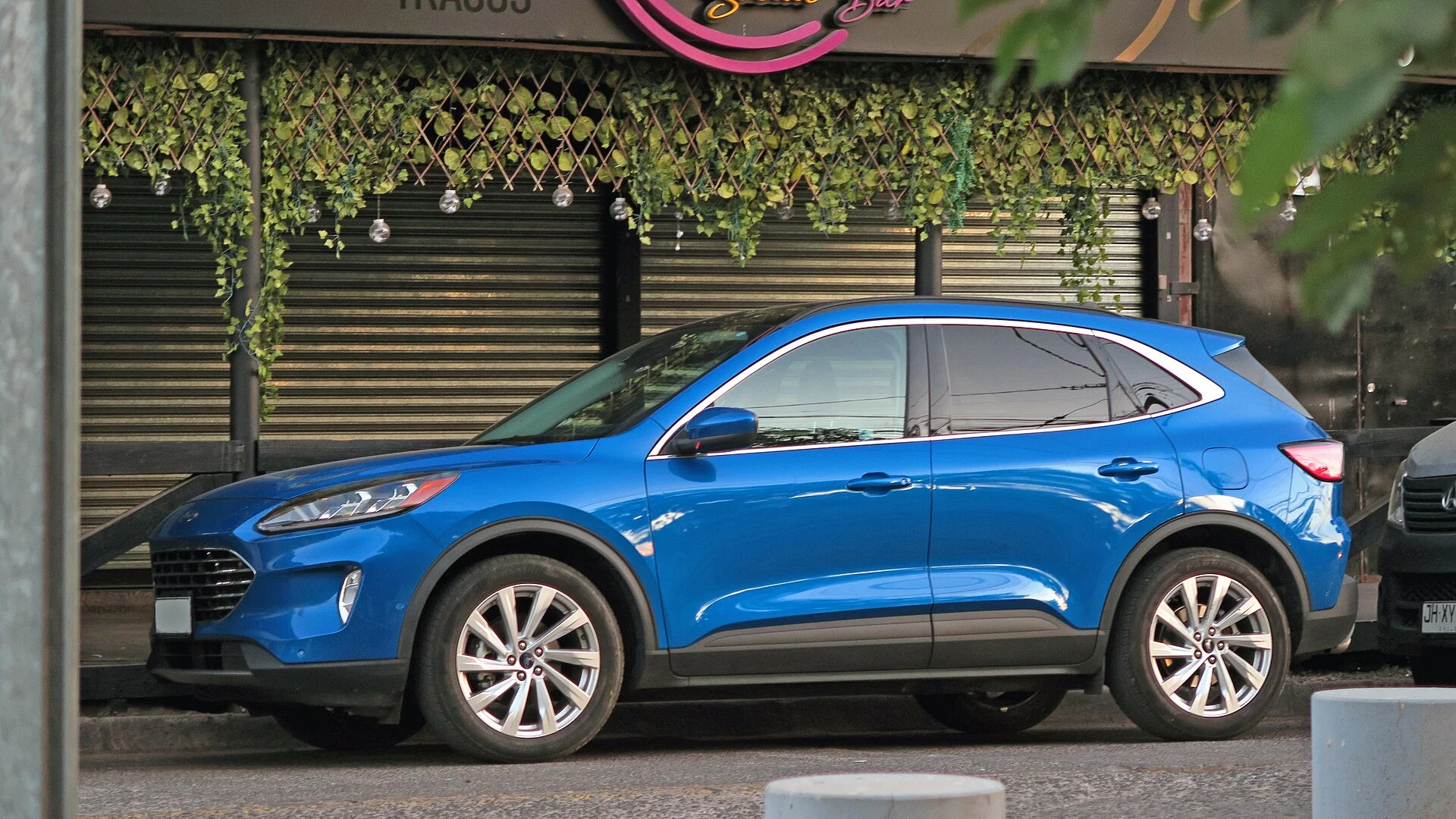 Blue 2021 Ford Escape Titanium SUV, side profile showing the full body length a sleeping-platform build fits into
