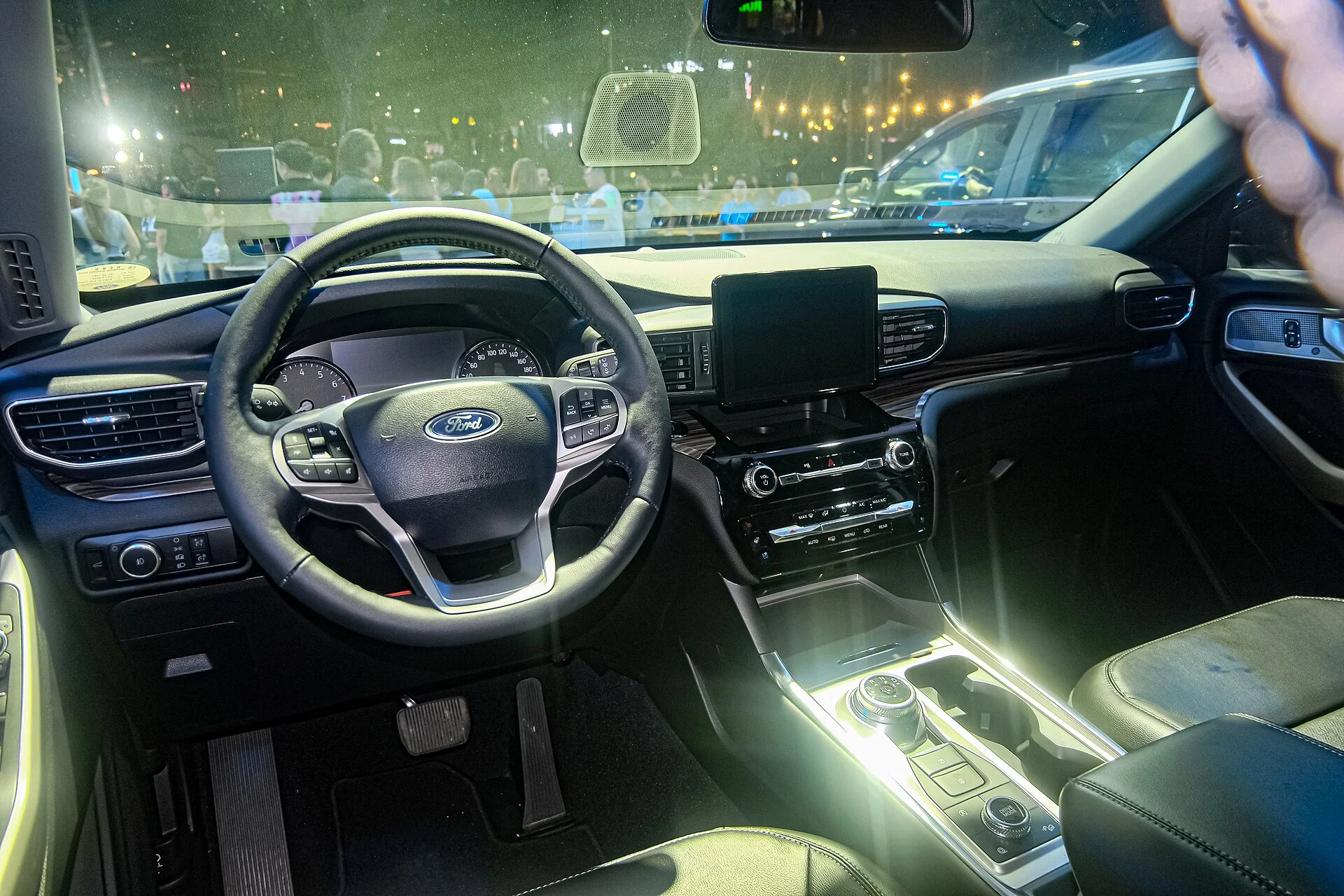 Ford Explorer (U625) cabin at night, the windshield area where a dash cam mounts