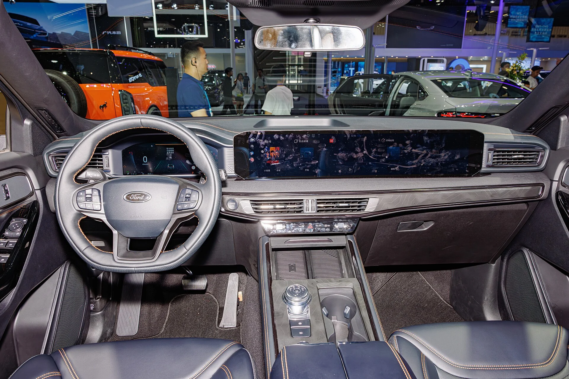 Ford Explorer (U625) dashboard from the driver's seat, the console a professional installer routes wiring behind