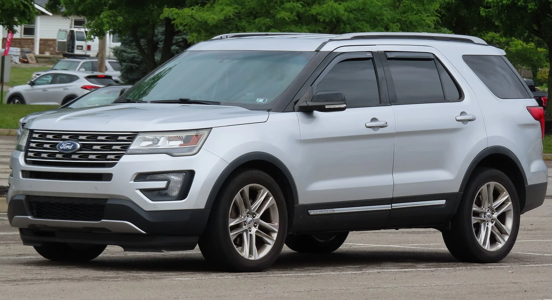 Ford Explorer XLT — a silver 2016 (previous-generation) Explorer, front three-quarter view