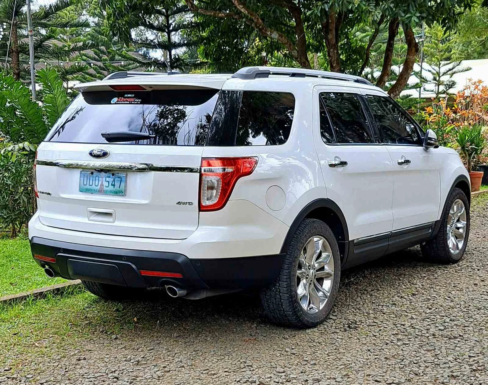 Ford Explorer Limited — a white 2011 (previous-generation) Explorer, rear three-quarter view