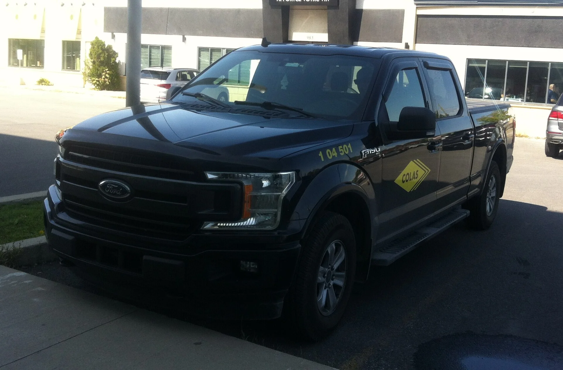 Black Ford F-150 crew cab (2018-2020), side showing the bed