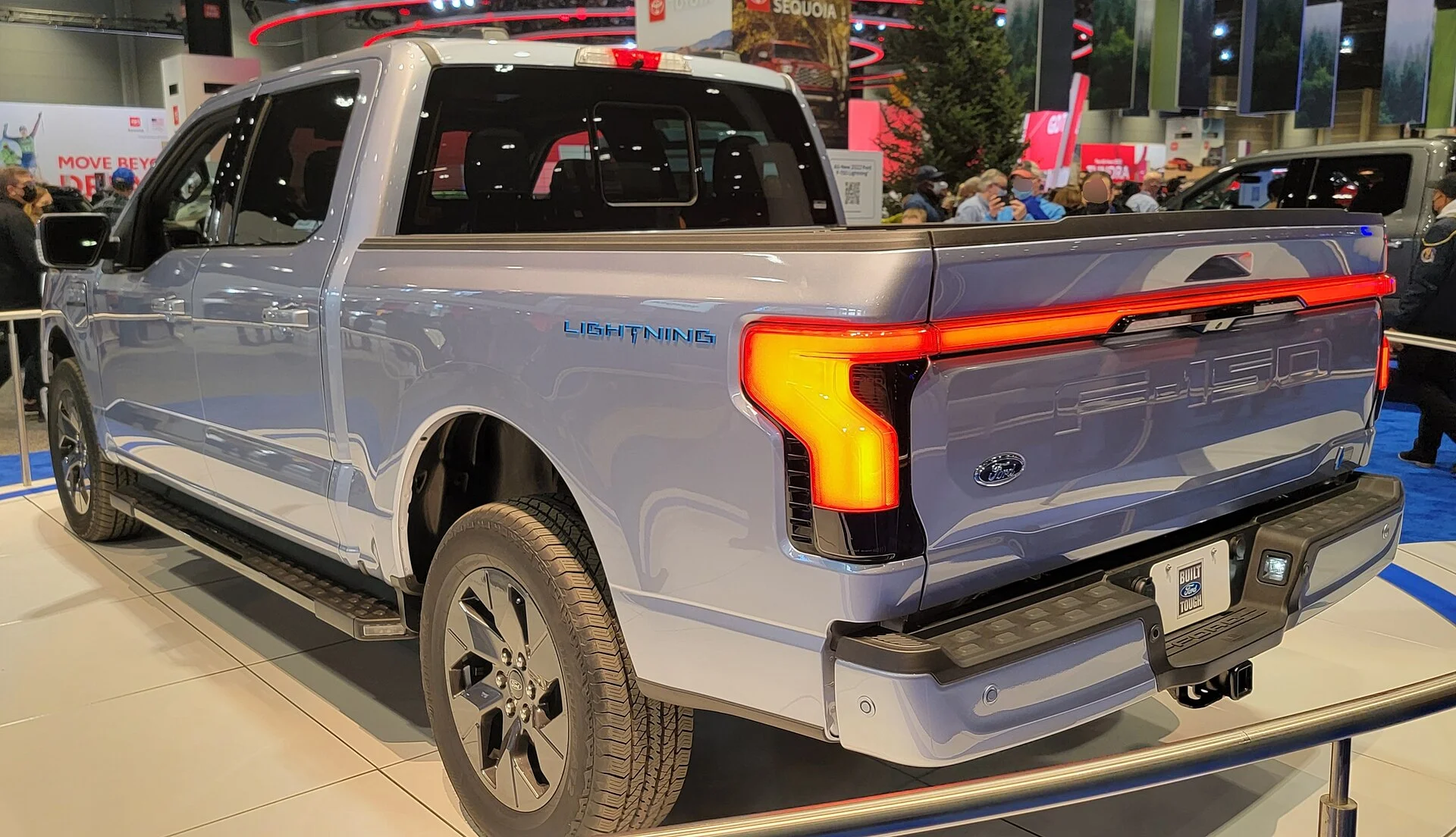 Ford F-150 Lightning — a silver 2022 Lightning, rear three-quarter view (the bed and tailgate that carry the Pro Power Onboard outlets)