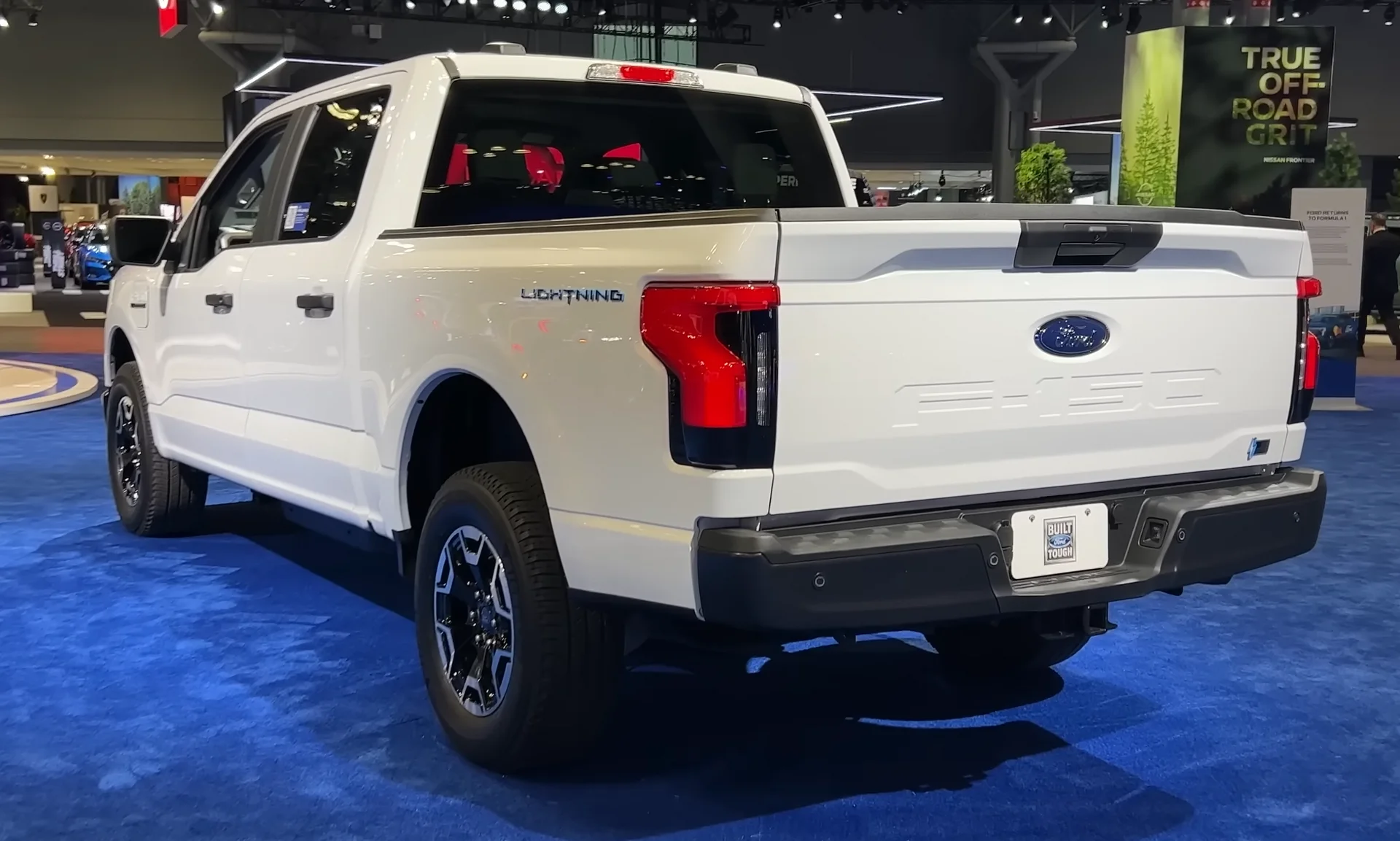 Ford F-150 Lightning Pro — a white 2023 Lightning, rear three-quarter view