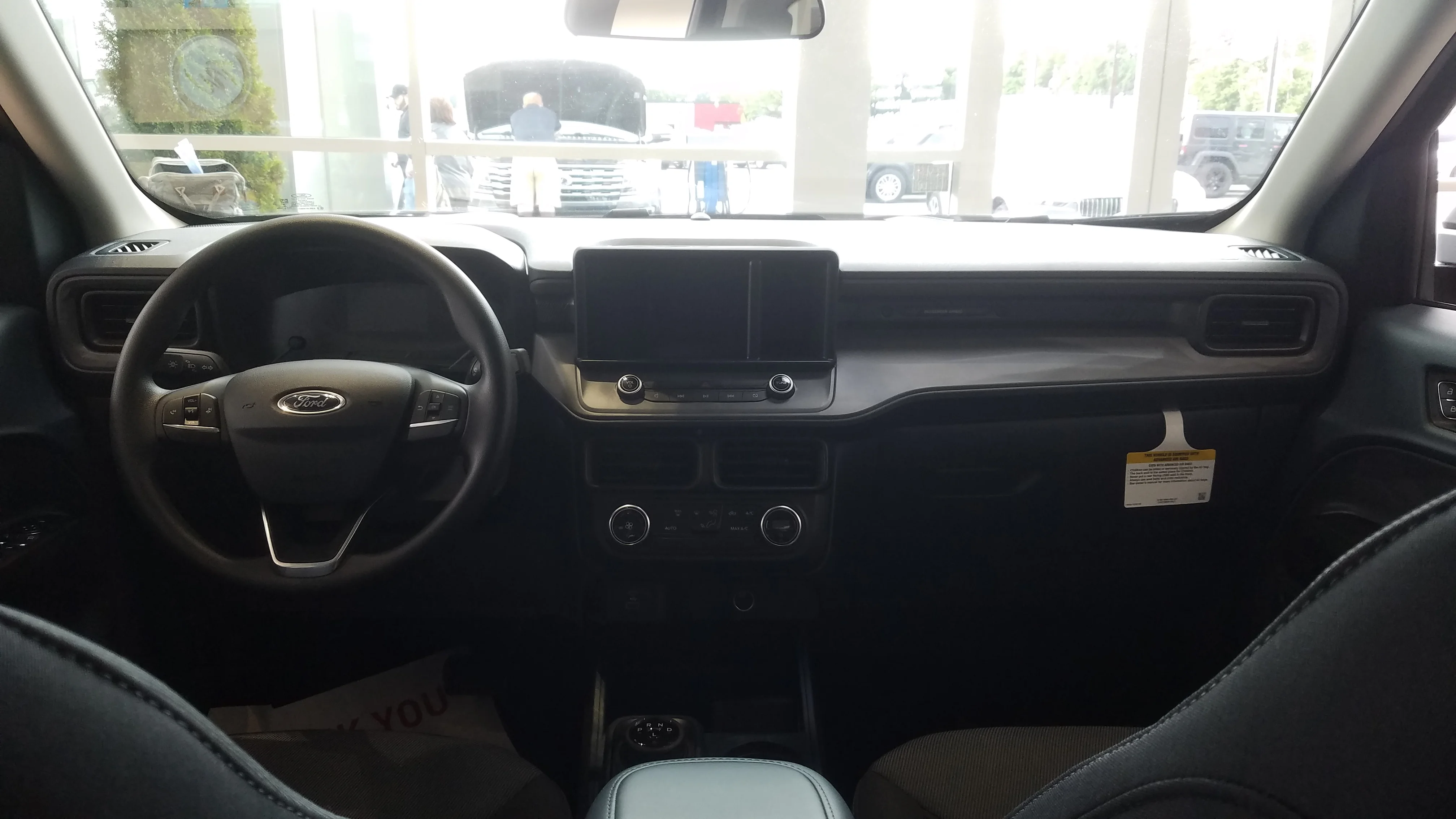 The Ford Maverick's cabin and dashboard, the compact pickup's interior beside its four-and-a-half-foot bed