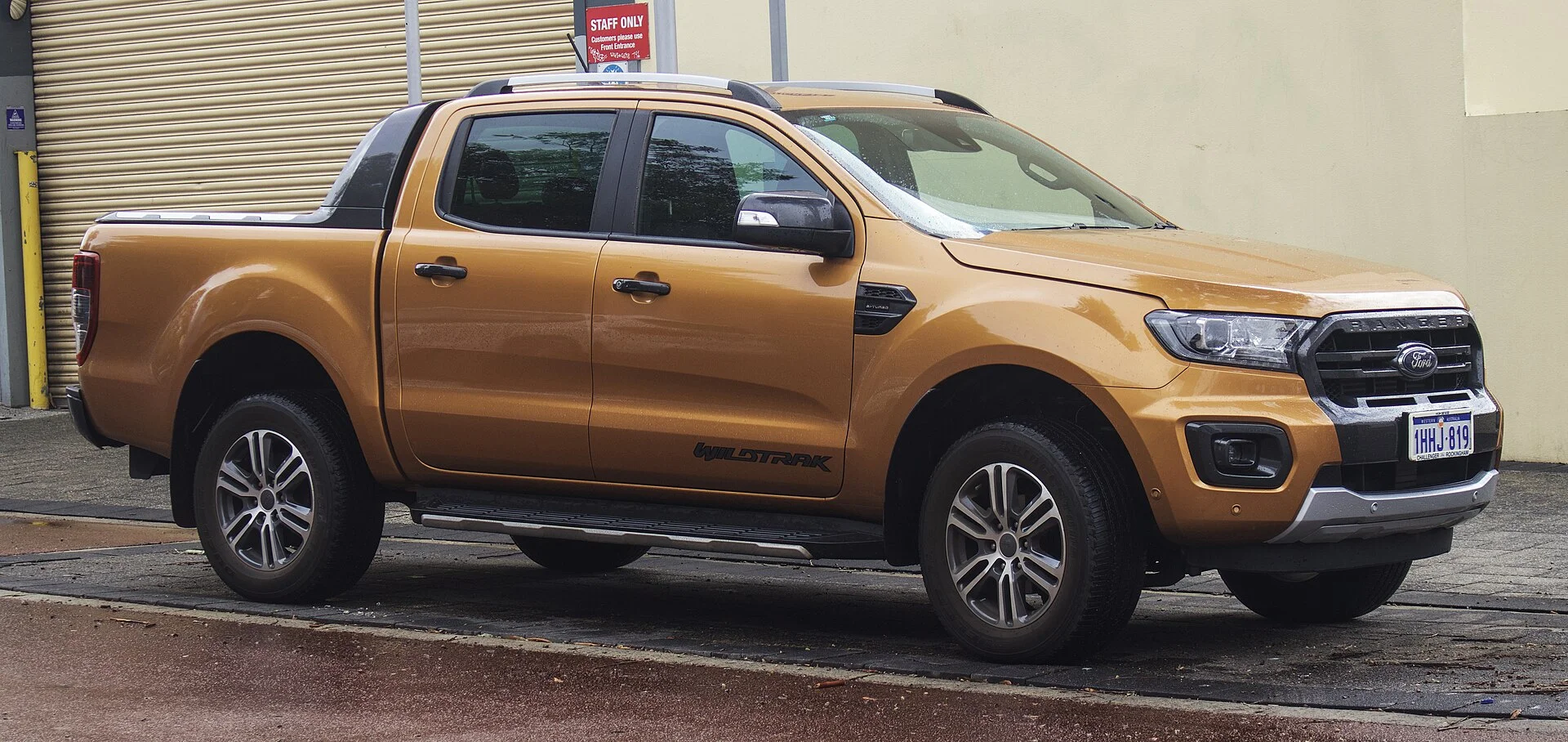 Orange Ford Ranger Wildtrak pickup, front three-quarter view (2020)