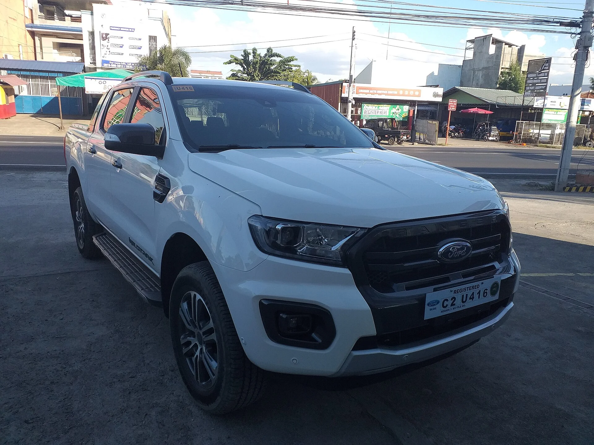 White Ford Ranger Wildtrak pickup parked, front side view (2020)