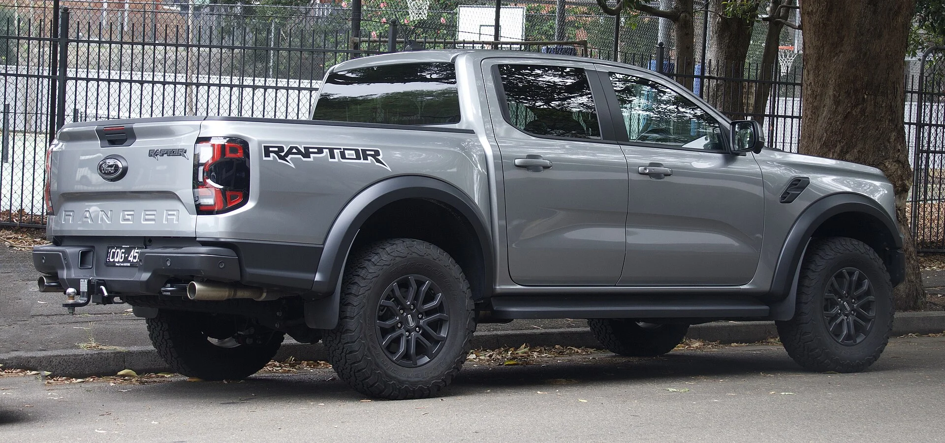 Grey Ford Ranger Raptor pickup, rear view showing the tailgate and rear bumper where a tow hitch mounts