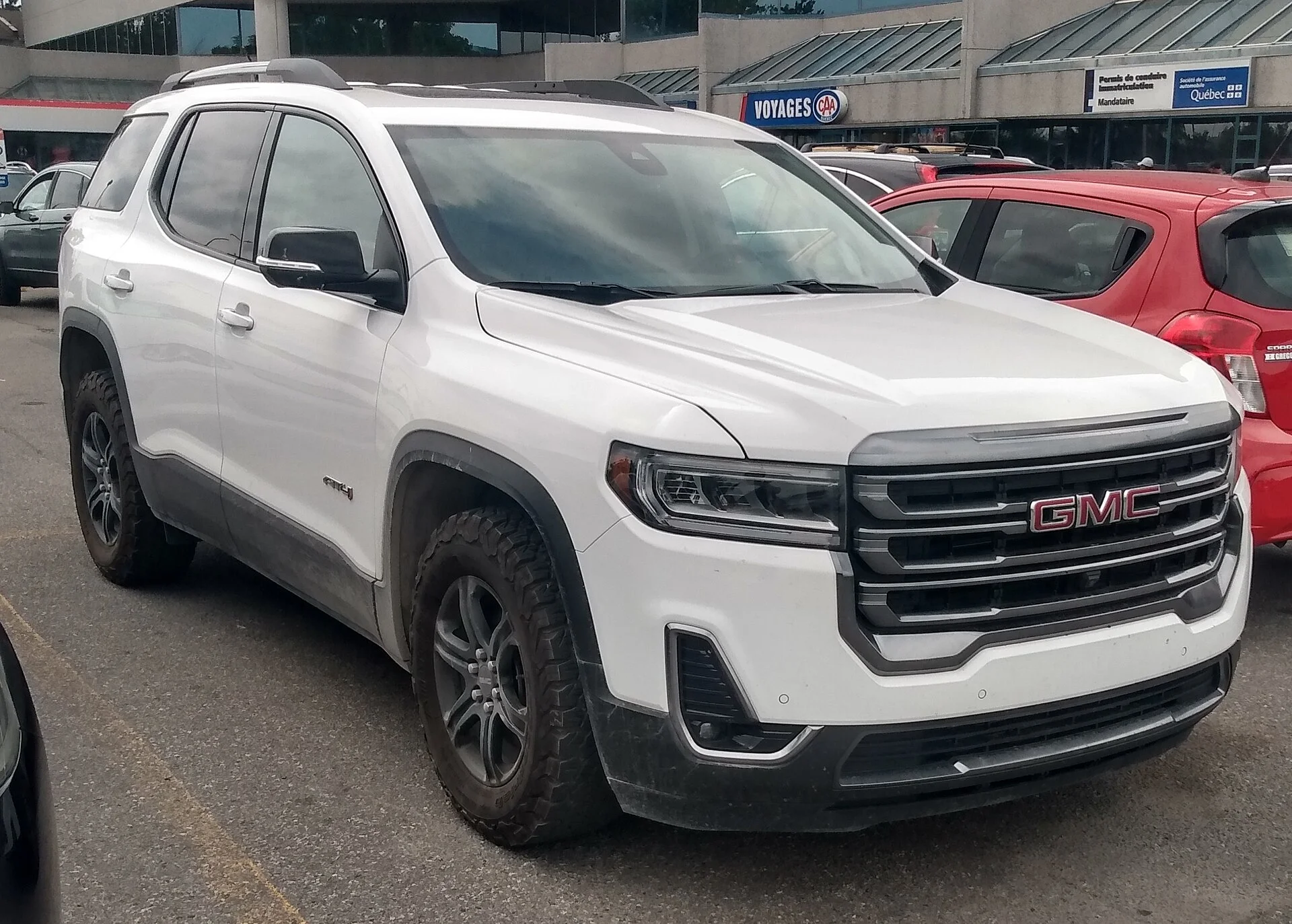 A GMC Acadia front three-quarter, the mid-size three-row SUV whose folded floor makes the family sleeping space