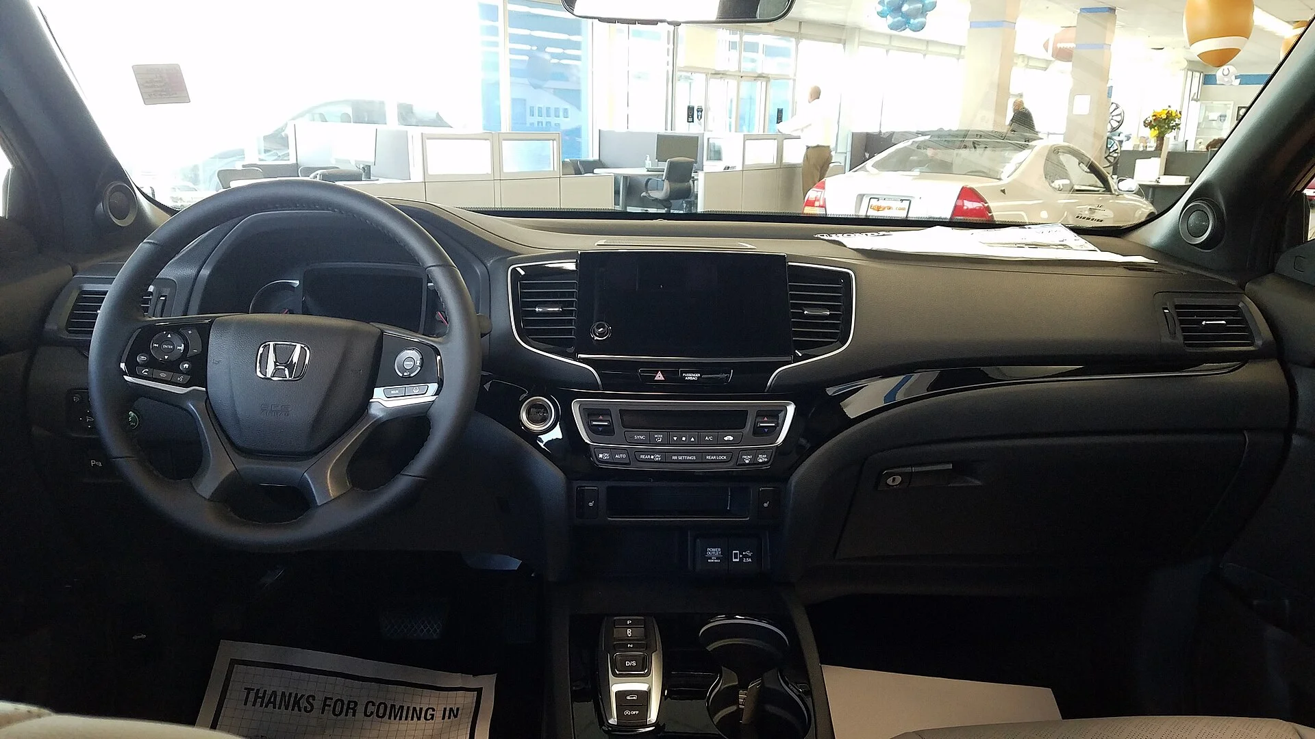 The Honda Passport's cabin and dashboard, the interior you set up behind for two-adult sleeping