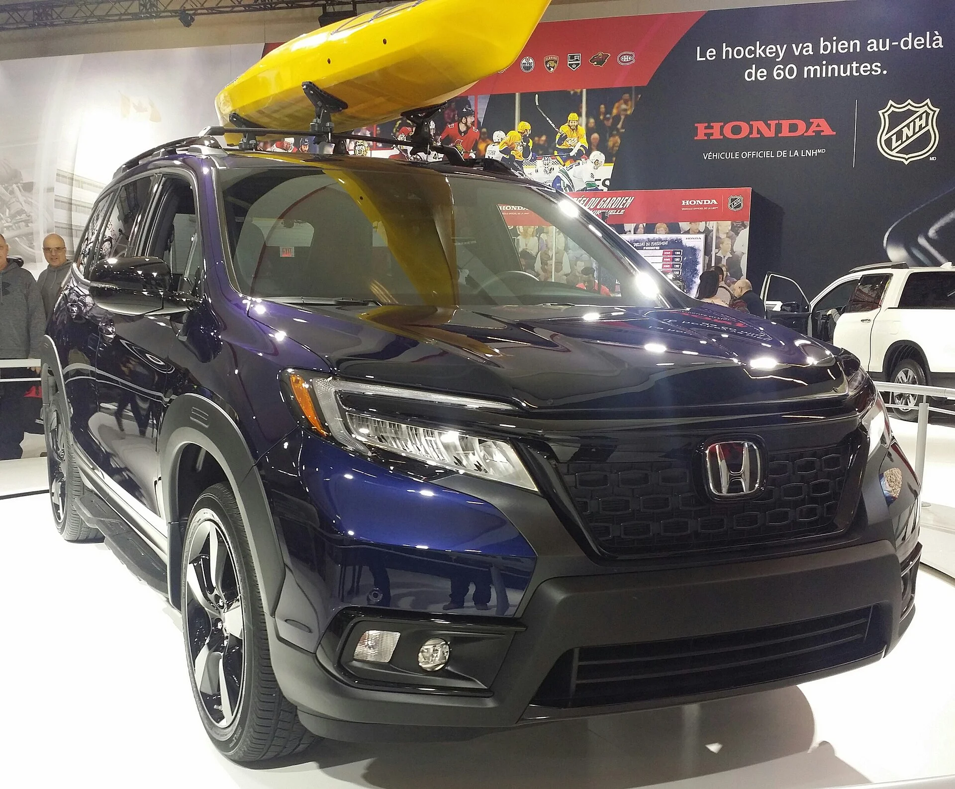 A Honda Passport with a kayak on the roof rails, the kind of trip its cargo hold is built for