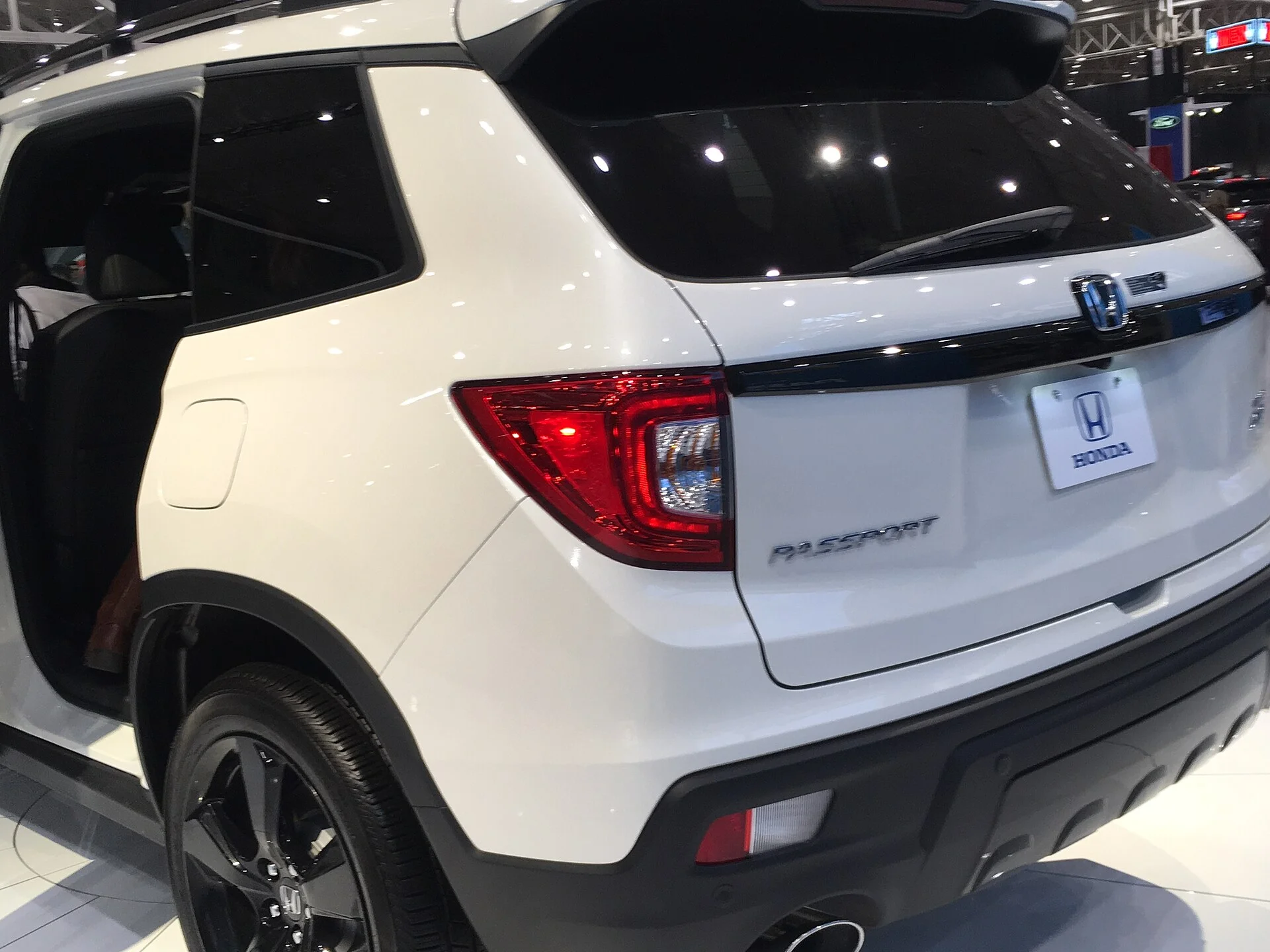 A Honda Passport rear three-quarter, showing the liftgate and cargo area you load the sleep platform through