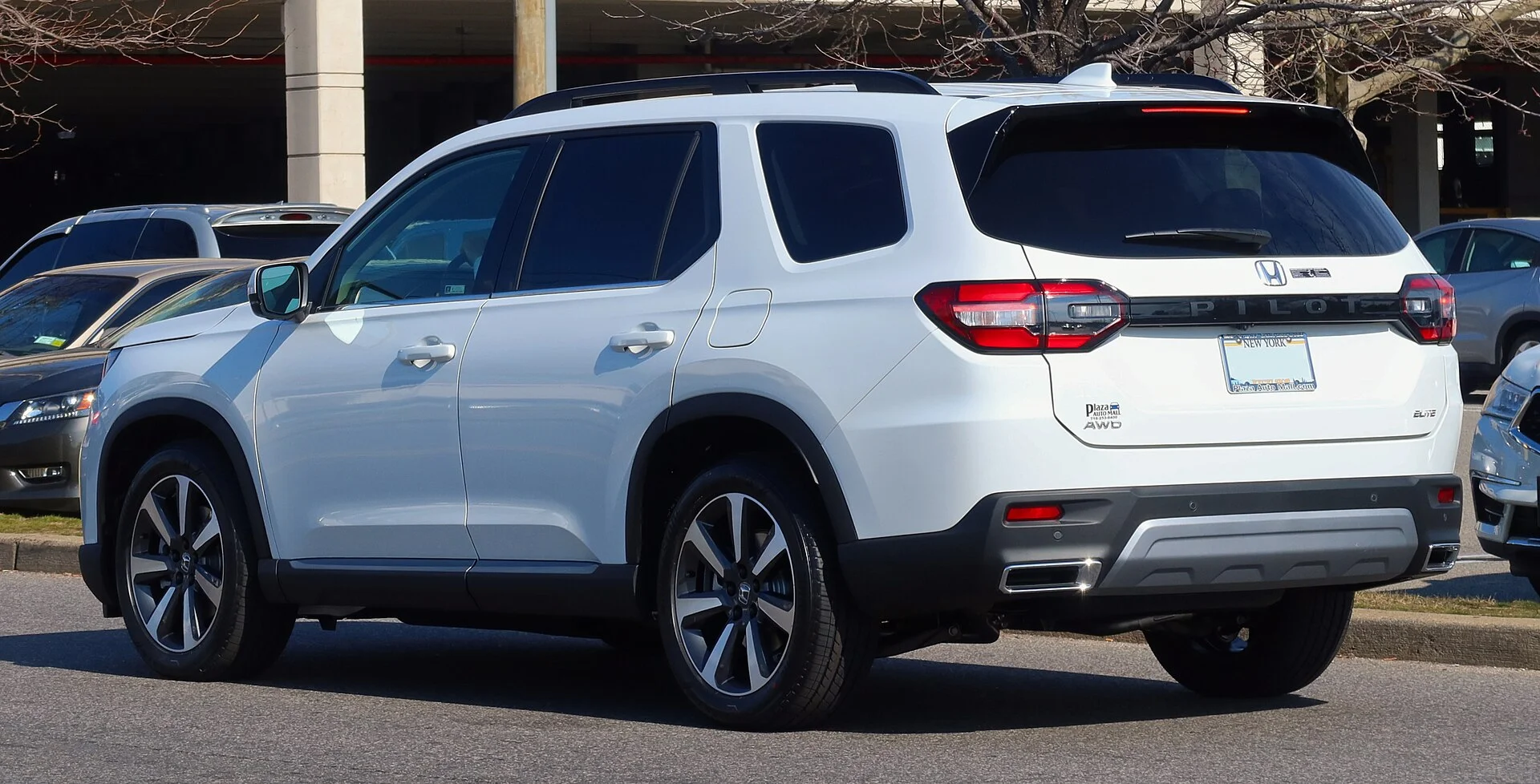 Honda Pilot Elite — a white 2023 Pilot, rear three-quarter view