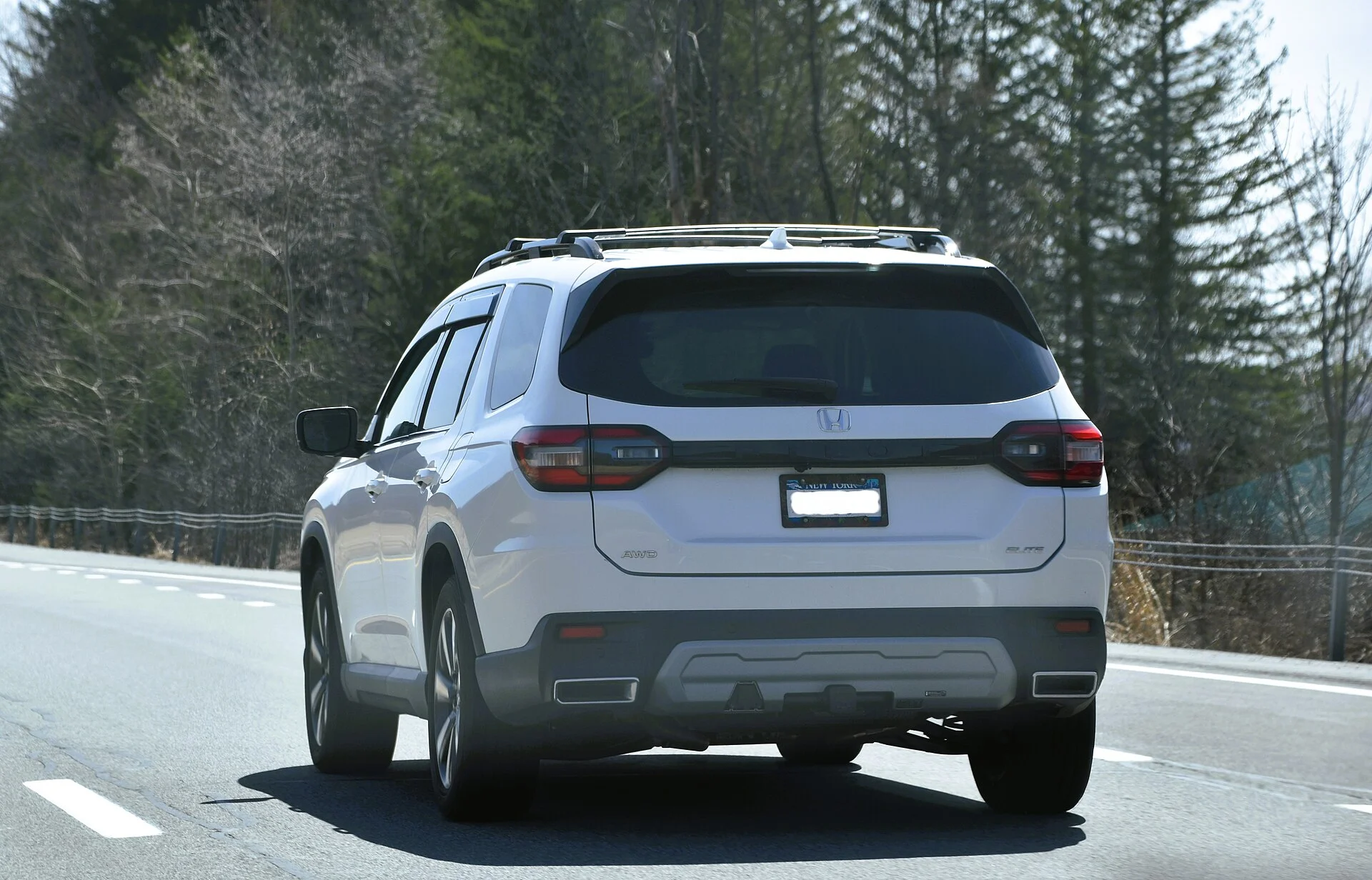 Silver 2023 Honda Pilot Elite SUV, rear view where the spare tire and jack are stored under the cargo floor