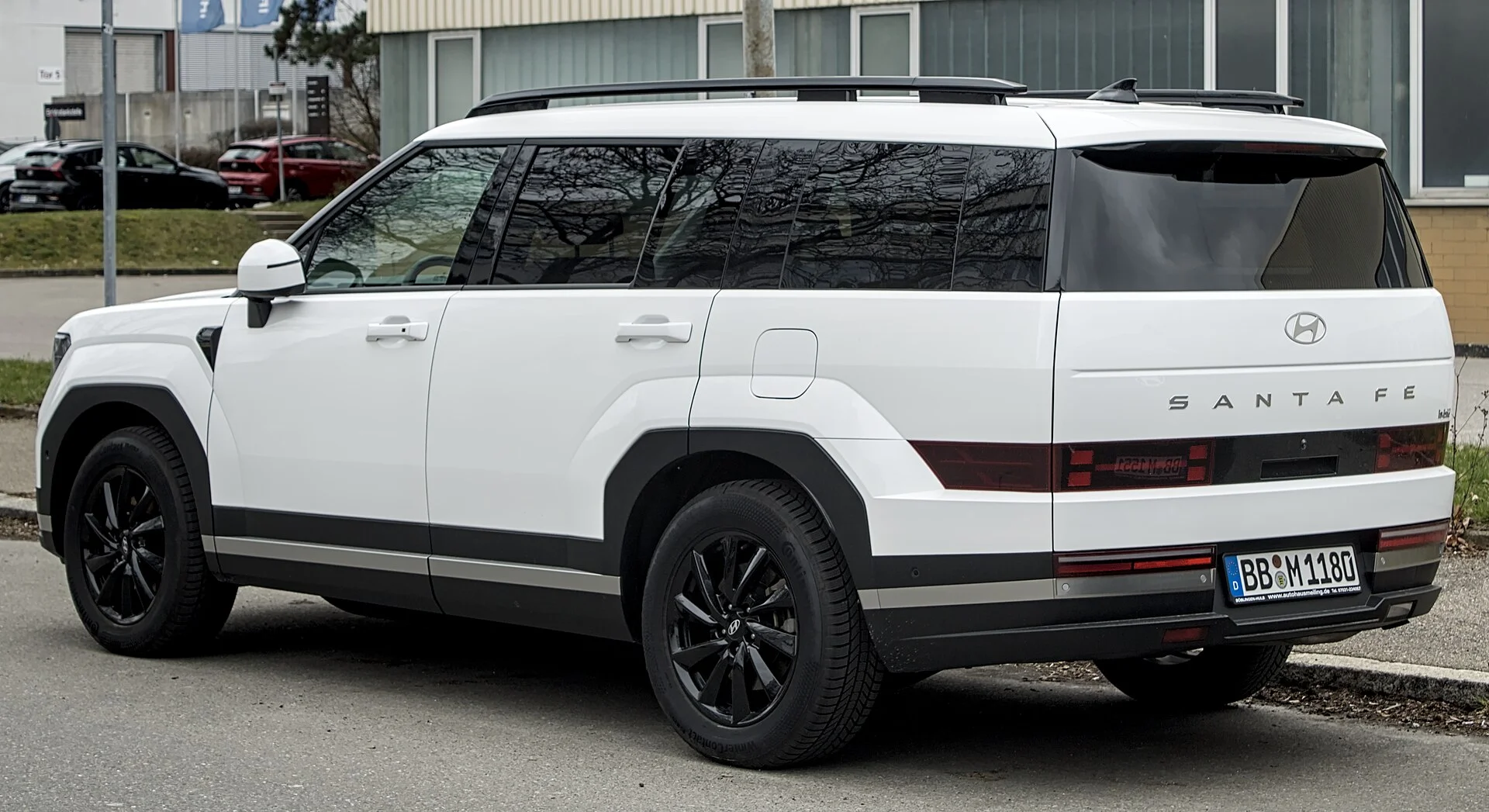 White Hyundai Santa Fe SUV, current MX5 generation with its boxy tailgate styling, rear three-quarter view.