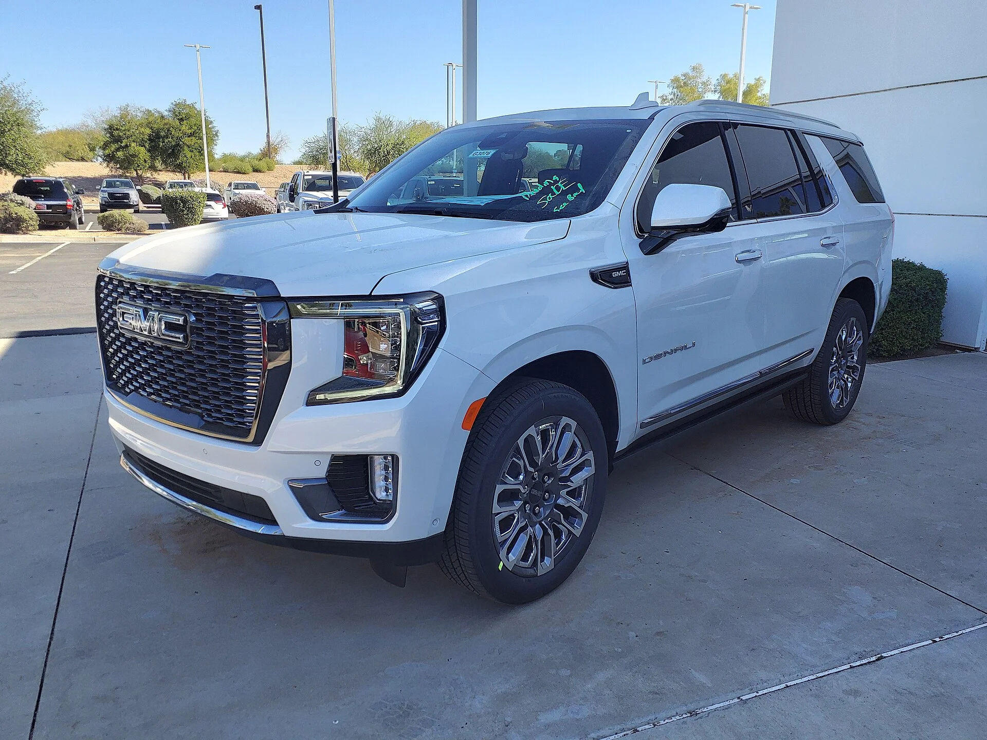 White GMC Yukon Denali, current generation, front three-quarter view