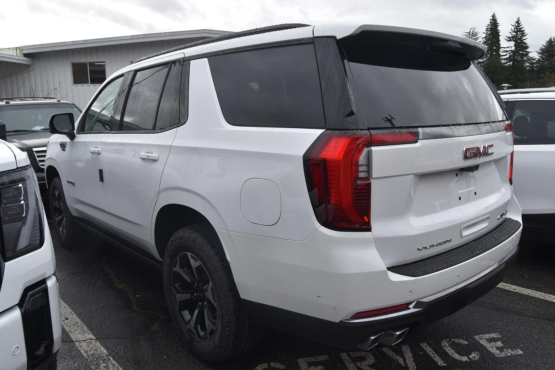 White GMC Yukon AT4, current generation, rear three-quarter view