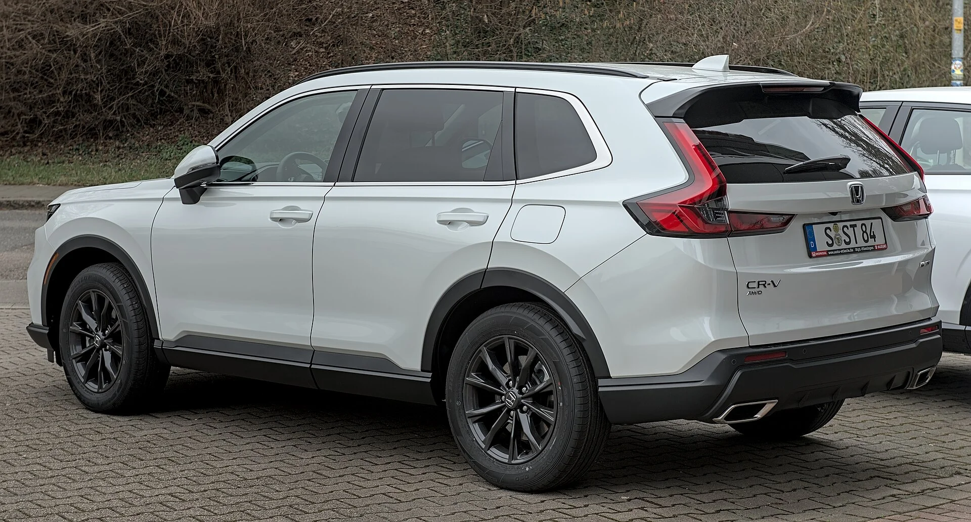 White Honda CR-V hybrid, sixth generation, side view