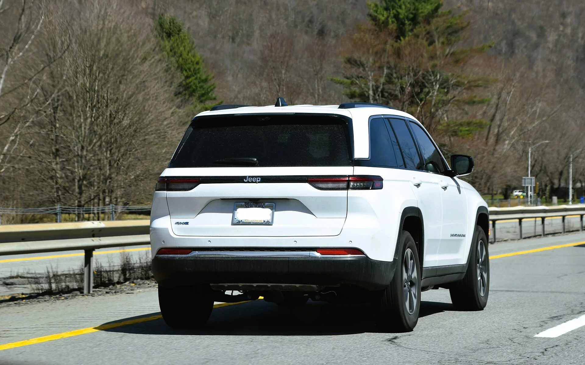 A white Jeep Grand Cherokee 4xe seen from the rear