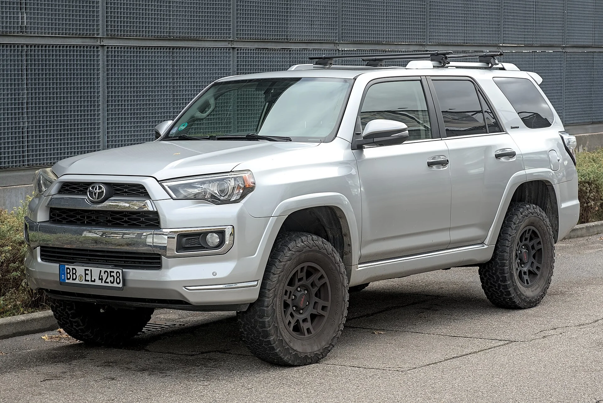 Silver Toyota 4Runner, front three-quarter view, lifted with a roof rack