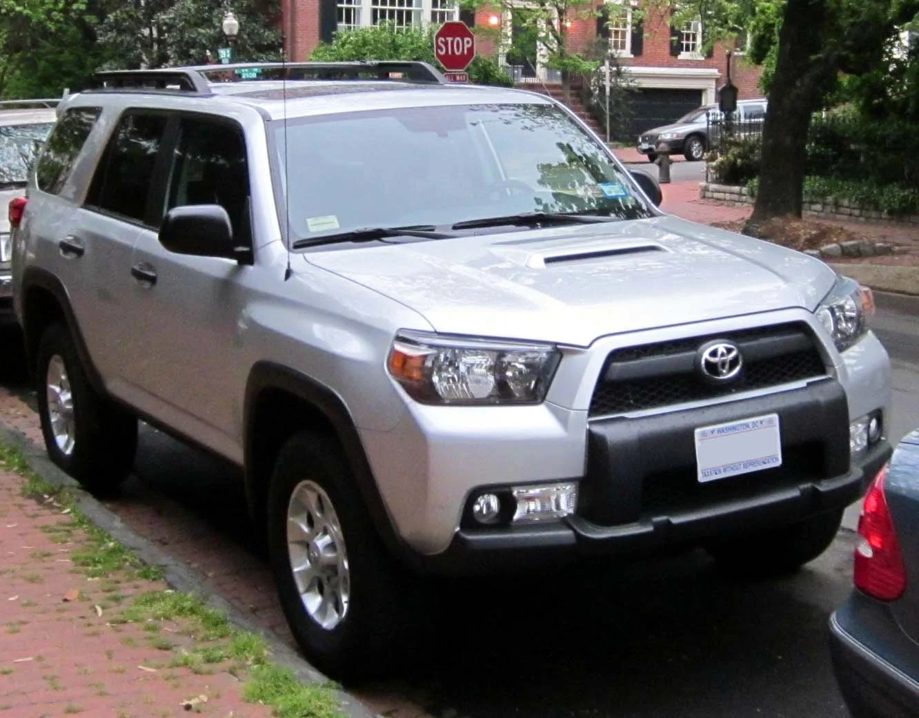 Silver Toyota 4Runner, front three-quarter view on a residential street