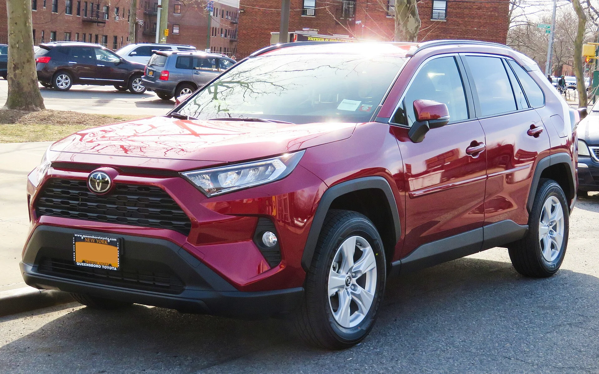 Red Toyota RAV4, current generation, front three-quarter view