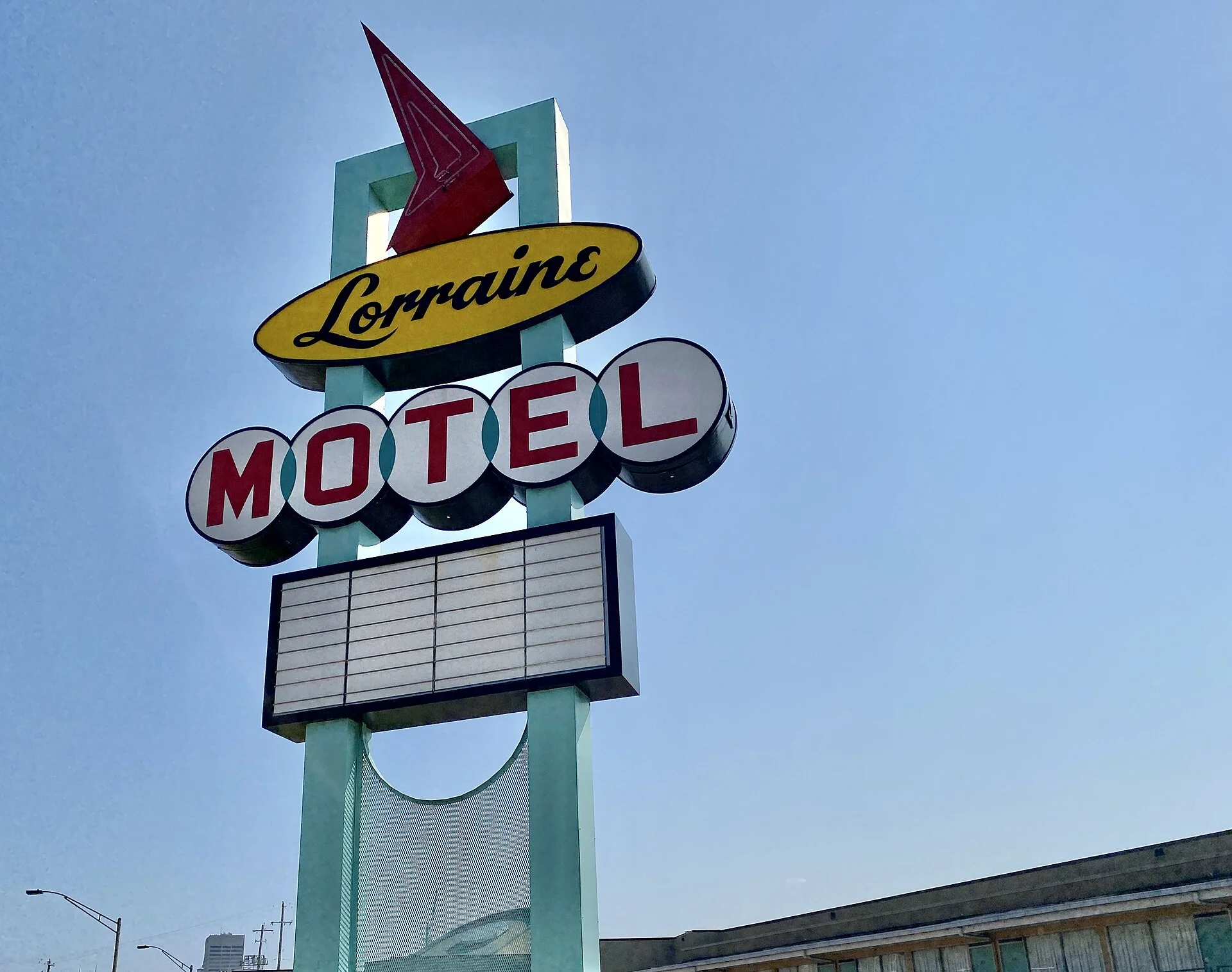 The illuminated sign of a roadside motel