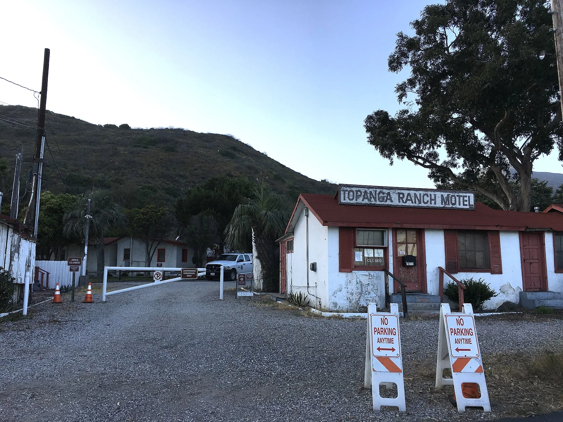 A single-storey roadside motel and its parking lot