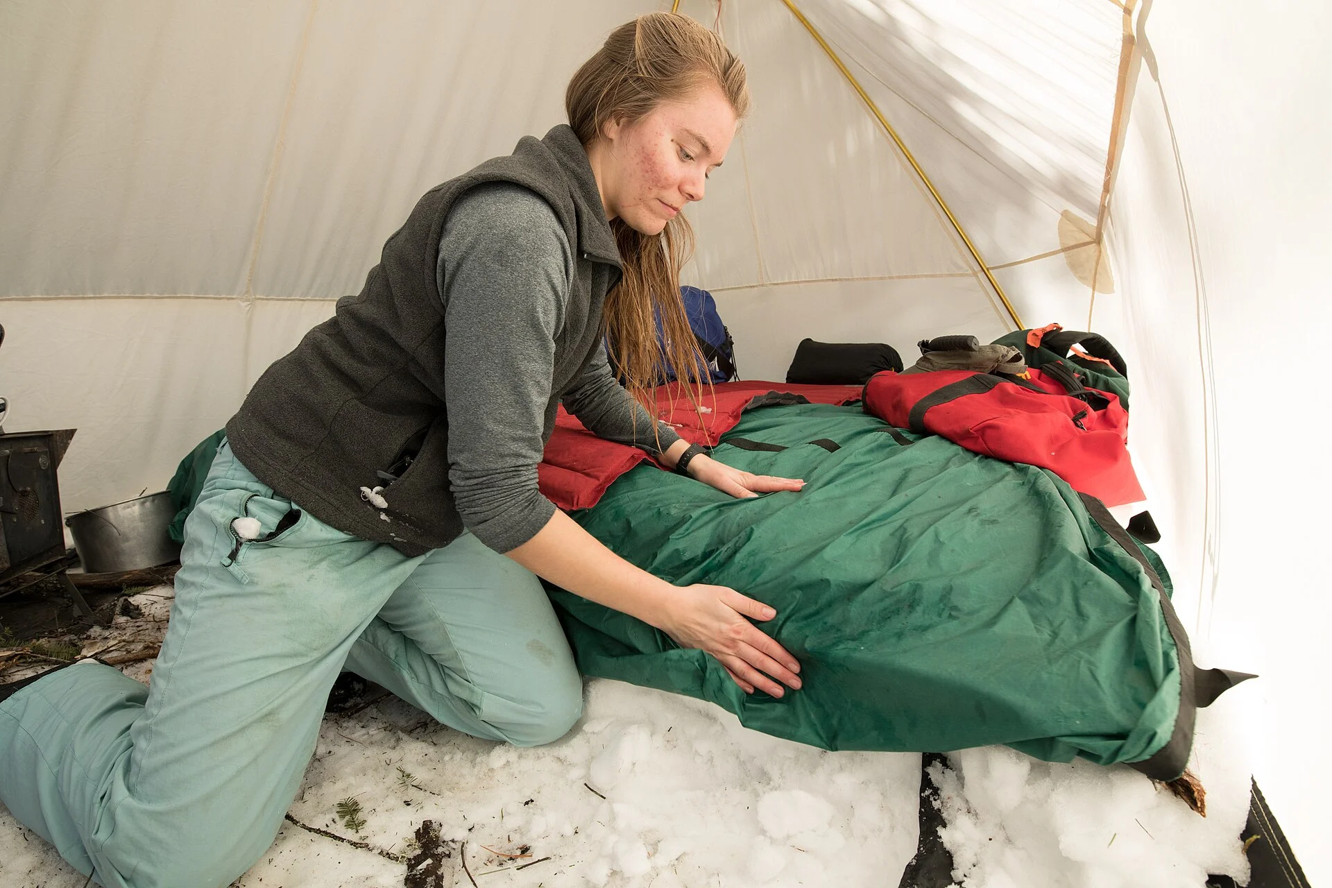 Setting up a sleeping bag at a camp in Superior National Forest