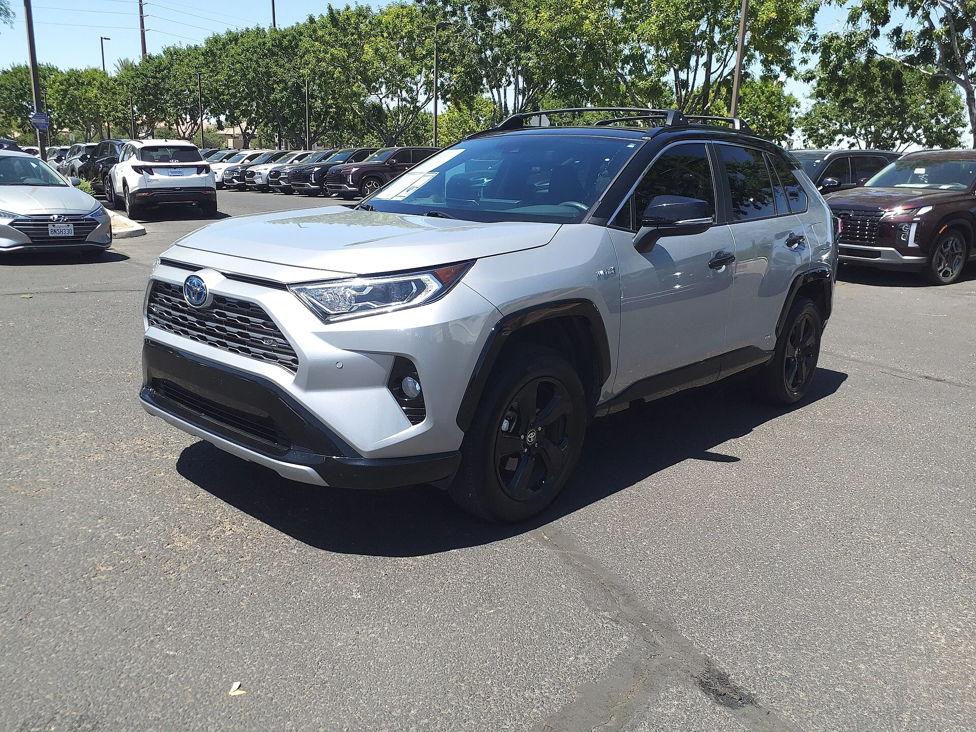 Silver Toyota RAV4 Hybrid, current generation, front three-quarter view