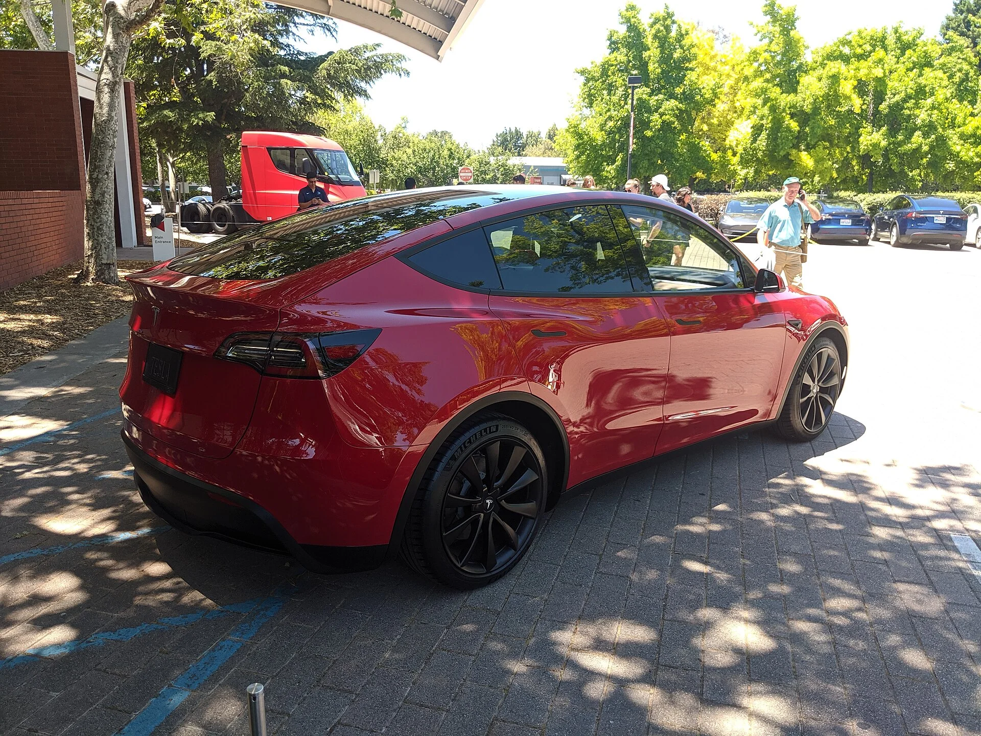 A red Tesla Model Y seen from the rear