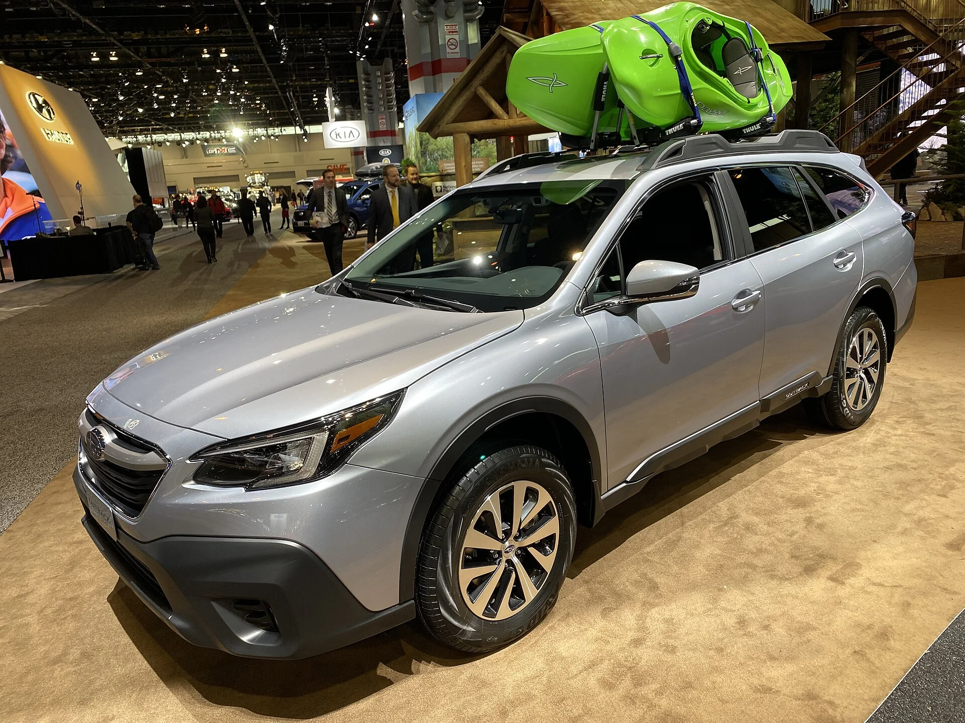 Silver Subaru Outback with a kayak on the roof, current generation, front three-quarter view
