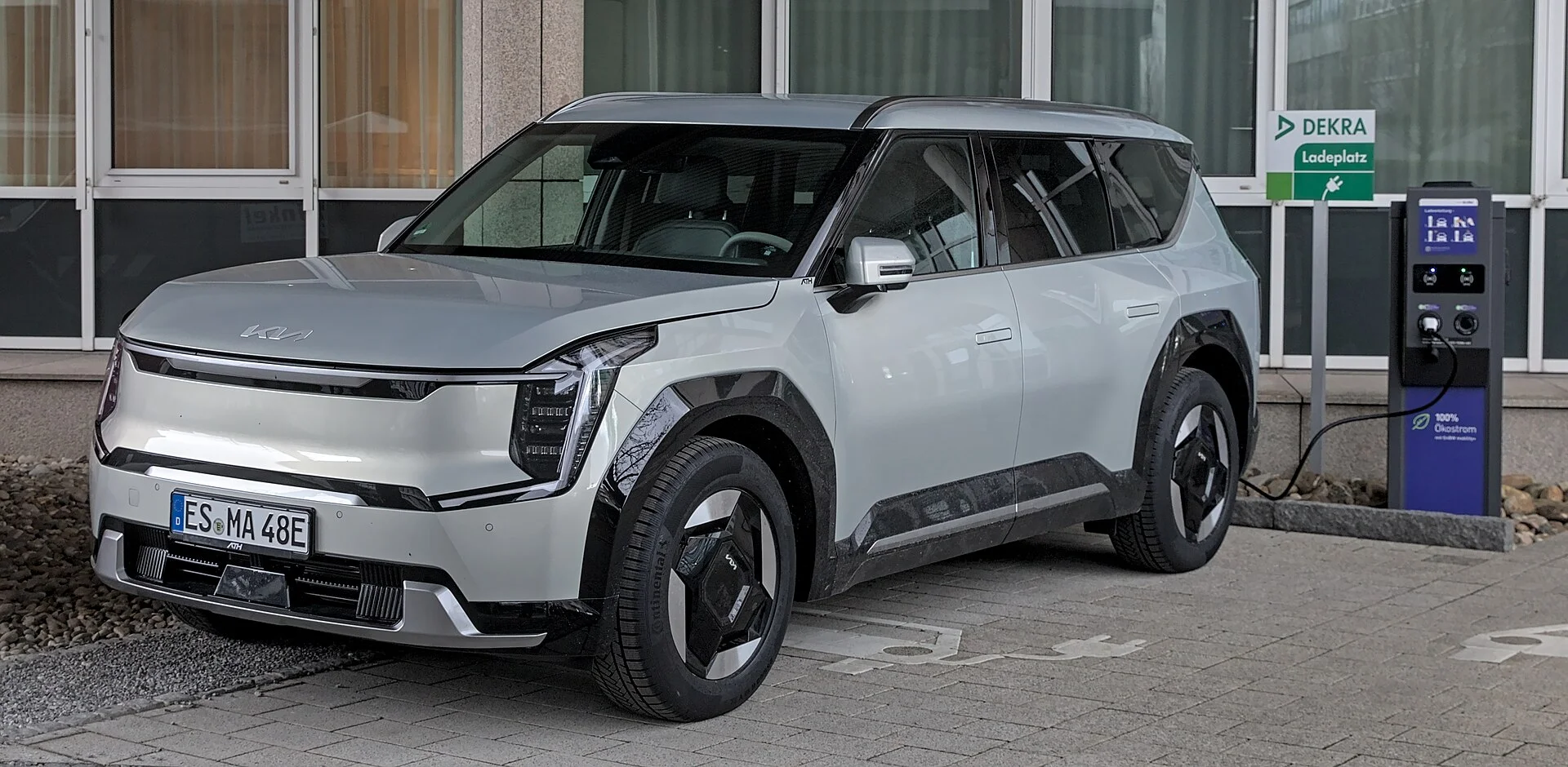 Grey Kia EV9 electric SUV plugged in and charging