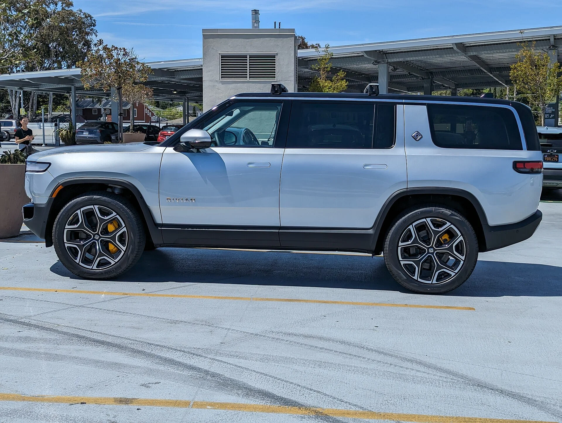 Rivian R1S in silver parked at a shopping center