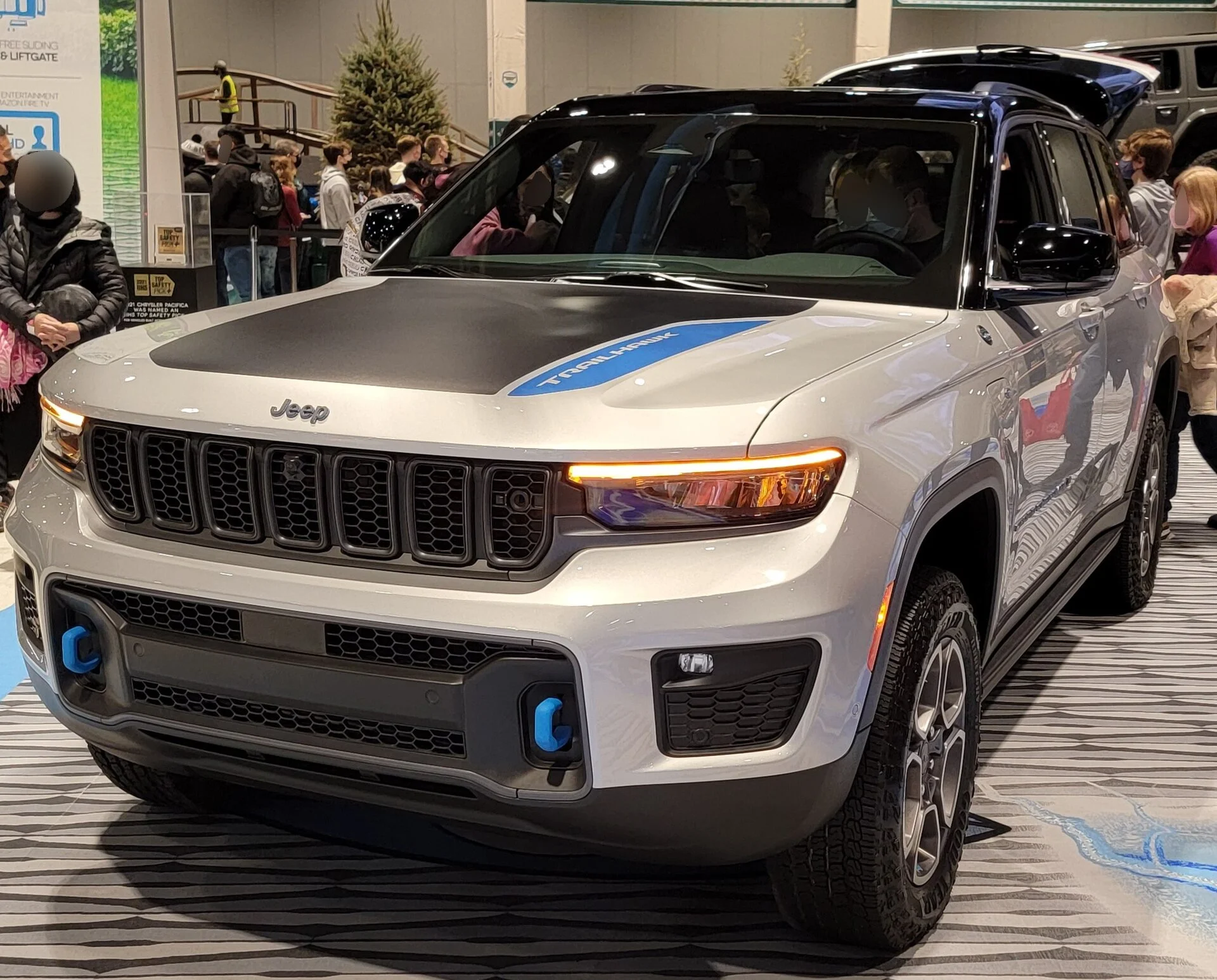 A sand-colored Jeep Grand Cherokee Trailhawk 4xe, front