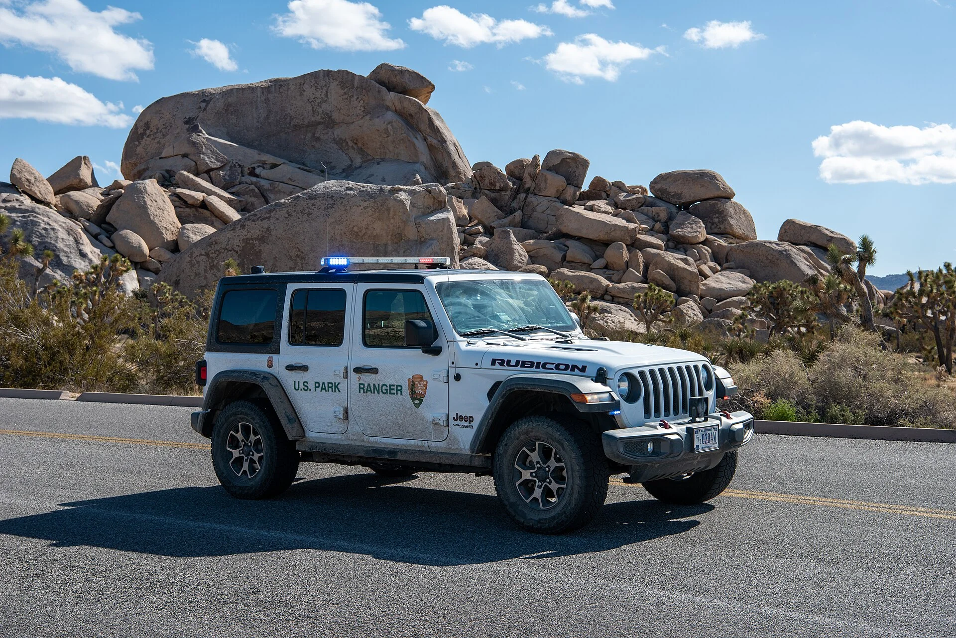 Jeep Wrangler (JL) parked on a desert road, the kind of off-grid trip that leans on the 12V system