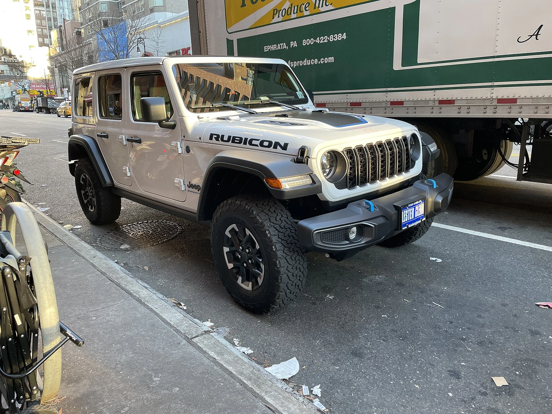 Jeep Wrangler Rubicon 4xe — a tan Wrangler on the street, front three-quarter view